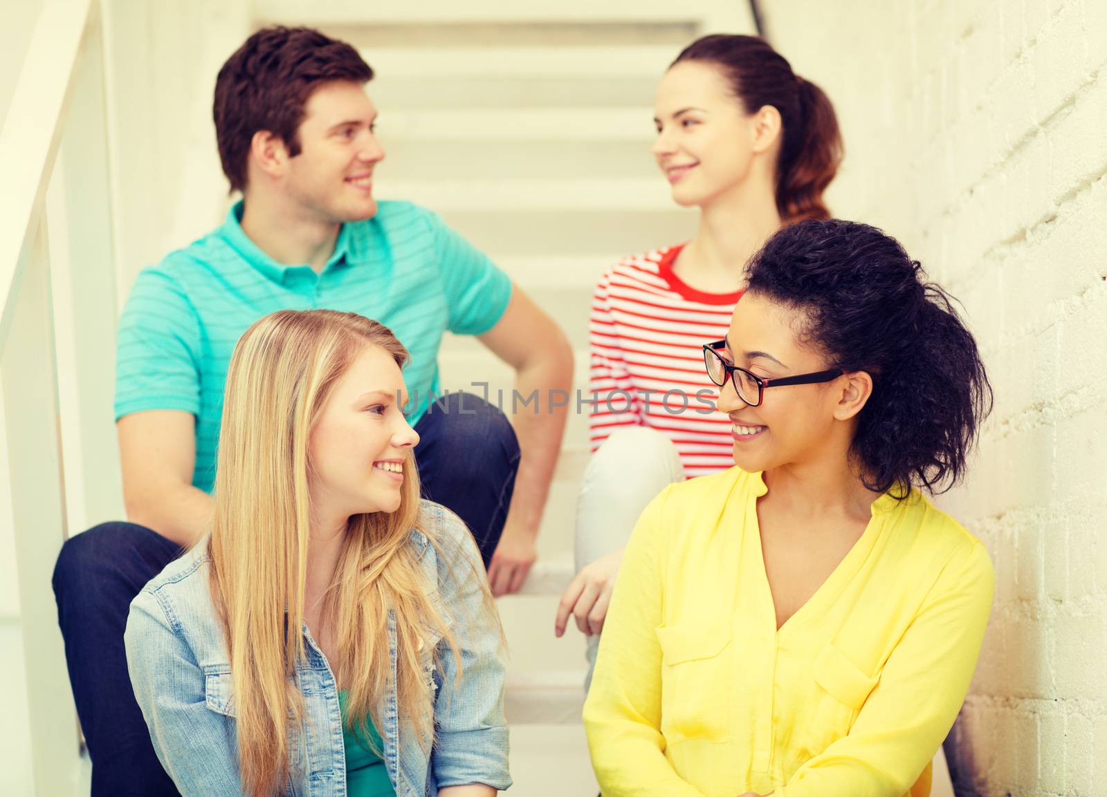 friendship and education concept - smiling teenagers hanging out