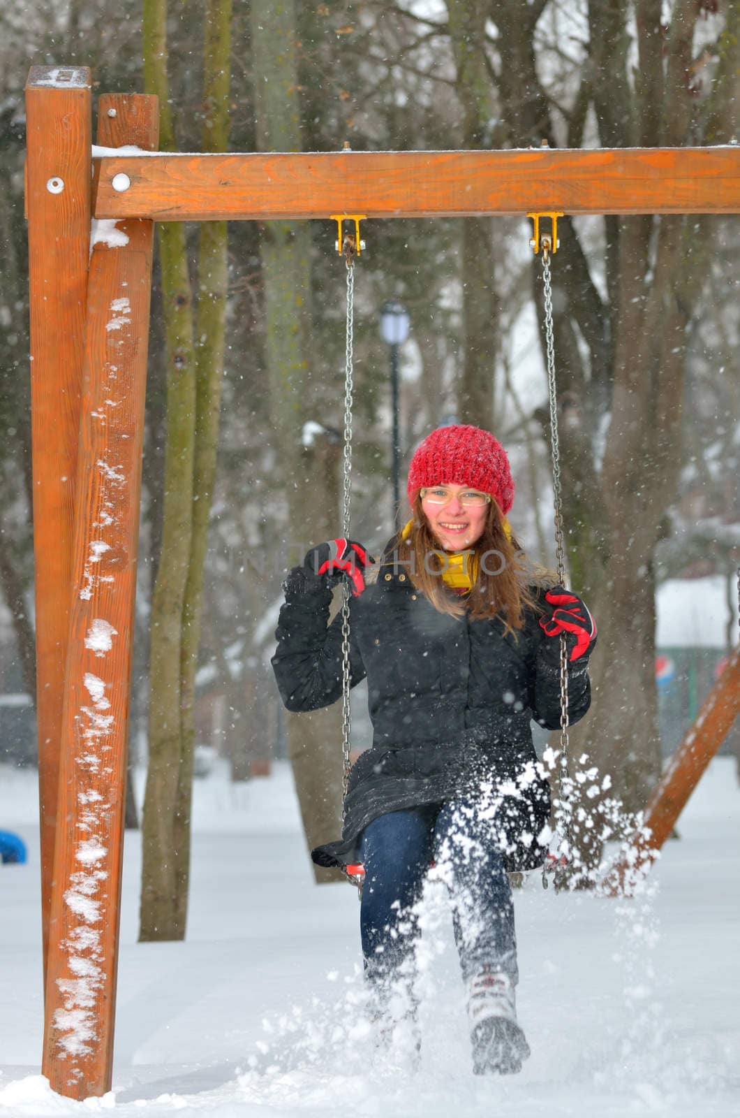 teen girl swing on snowy winter day