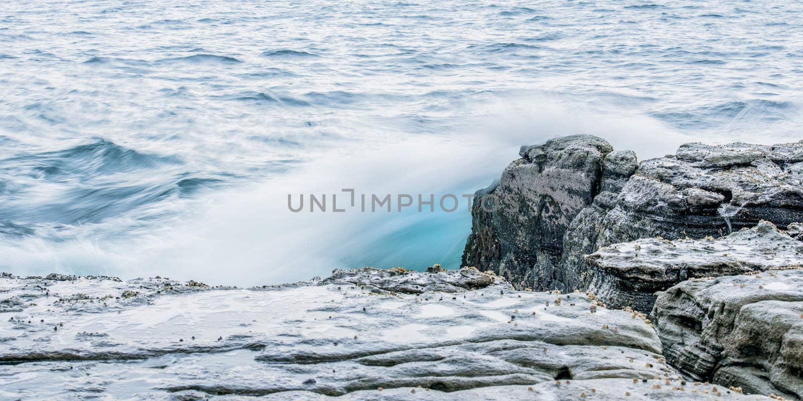 Rocks and waves at Point Cartwright beach in the afternoon. Sunshine Coast, Queensland.