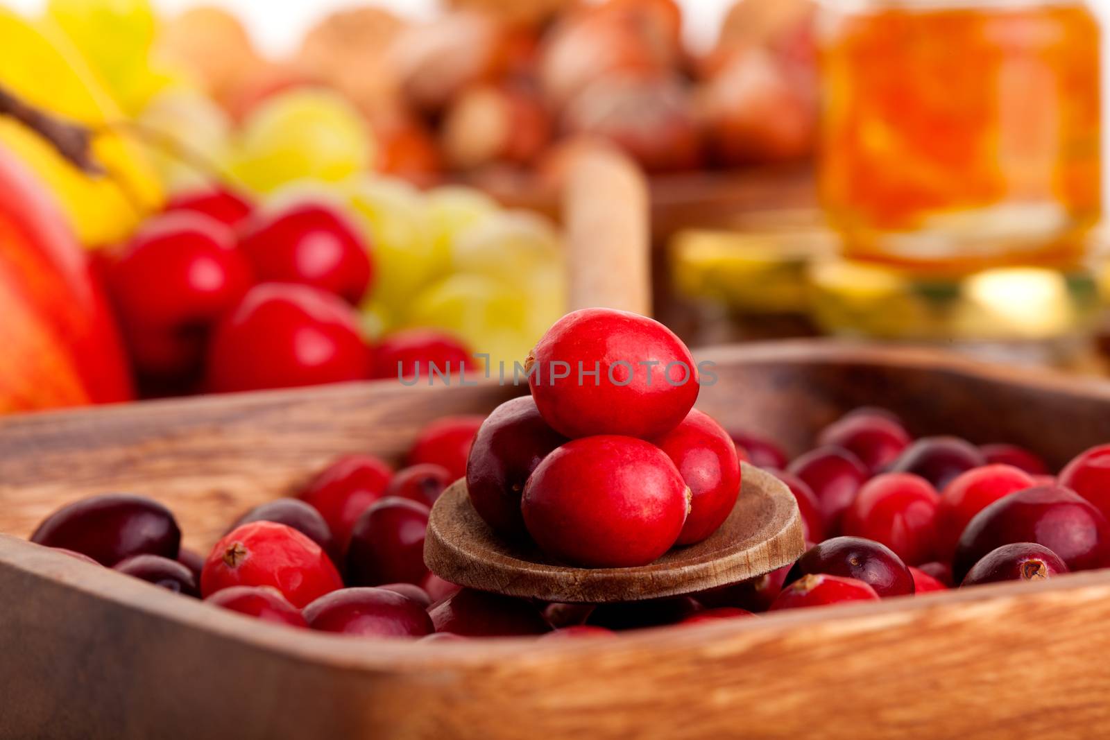 Cranberries in wooden bowl. macro shot by motorolka