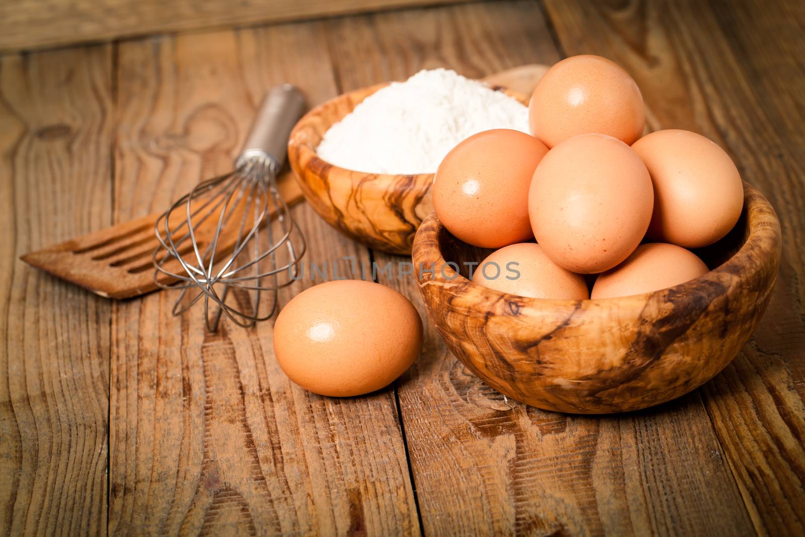 flour and eggs, ingredients for baking. on wooden background