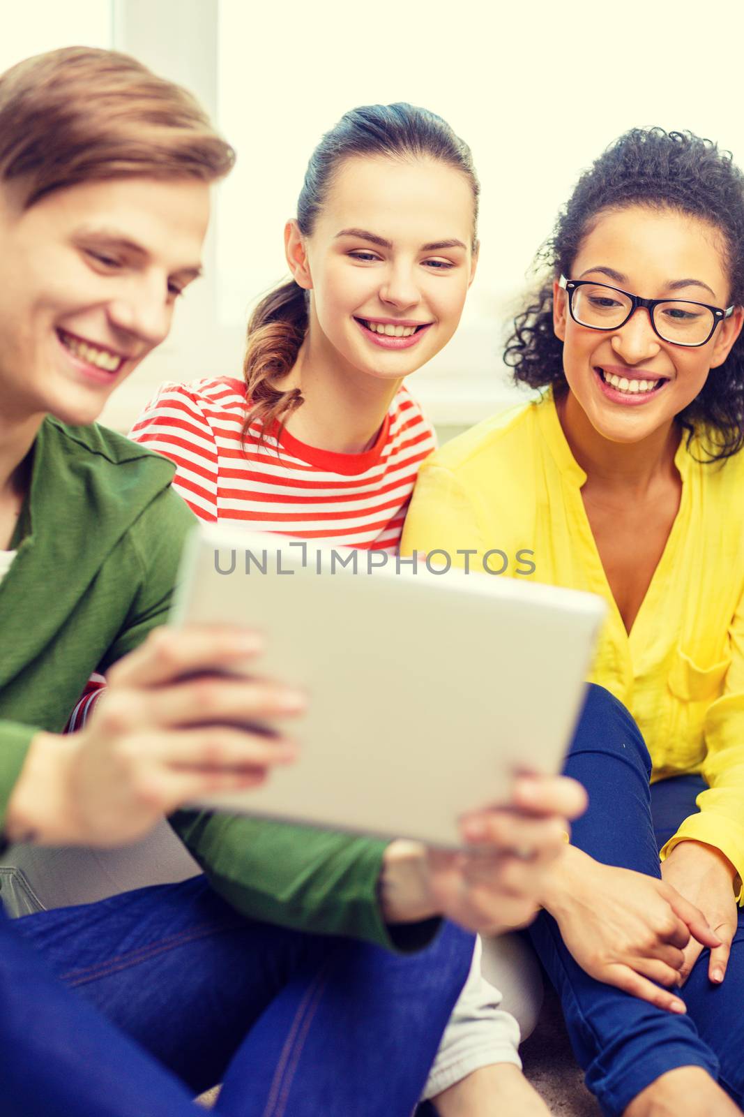 smiling students with tablet pc computer by dolgachov