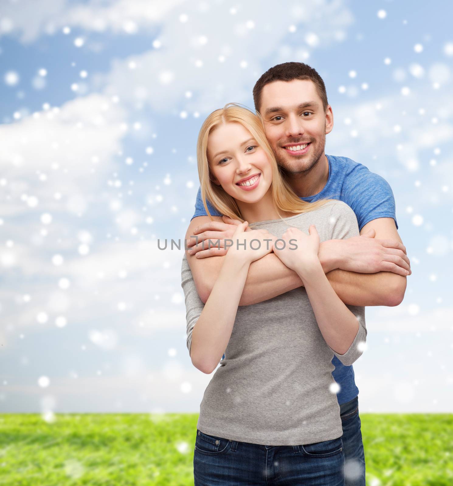 happy couple hugging outdoors by dolgachov