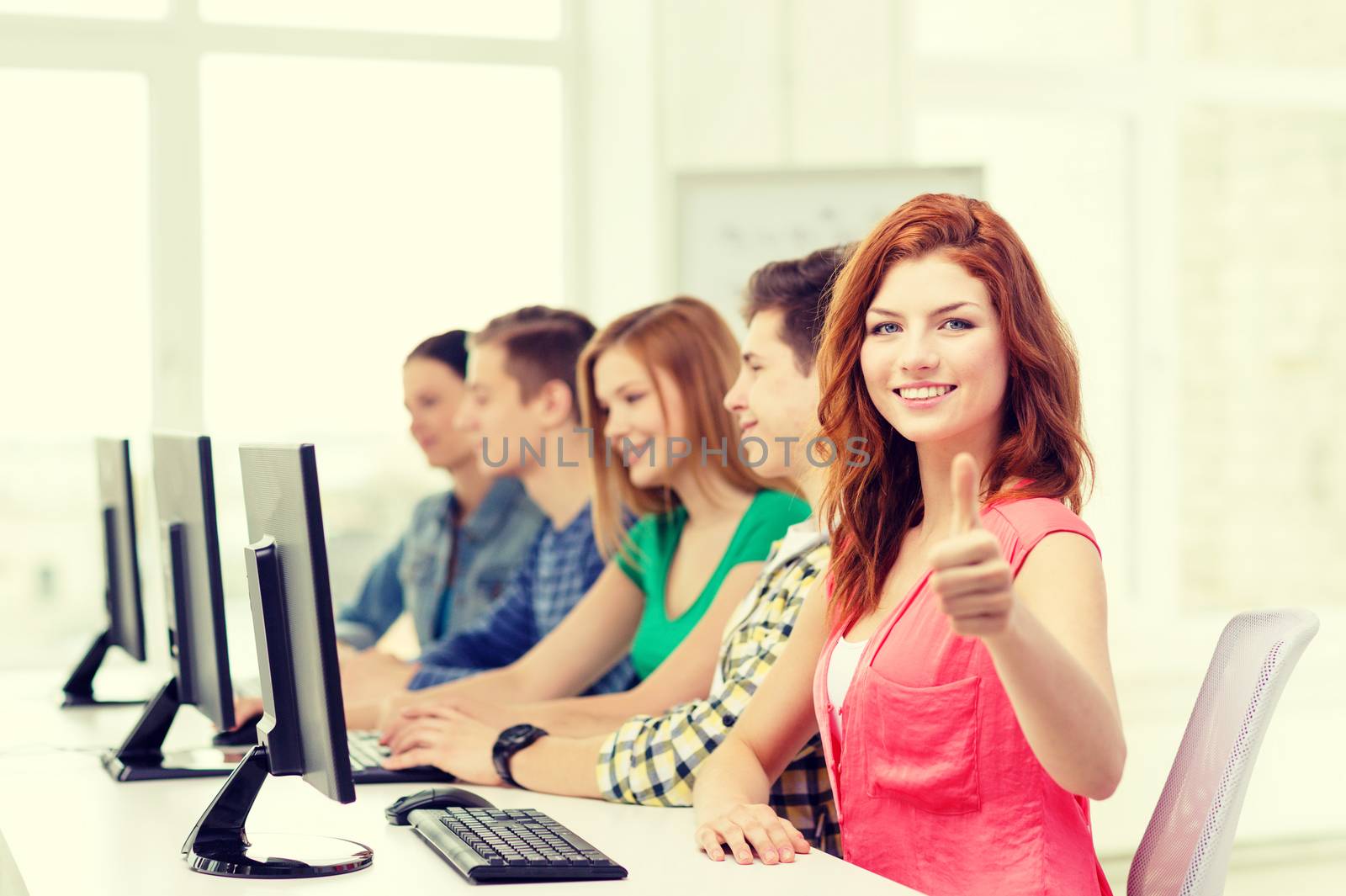 female student with classmates in computer class by dolgachov