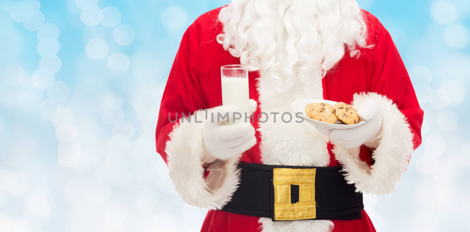 christmas, holidays, food, drink and people concept -close up of santa claus with glass of milk and cookies over blue lights background
