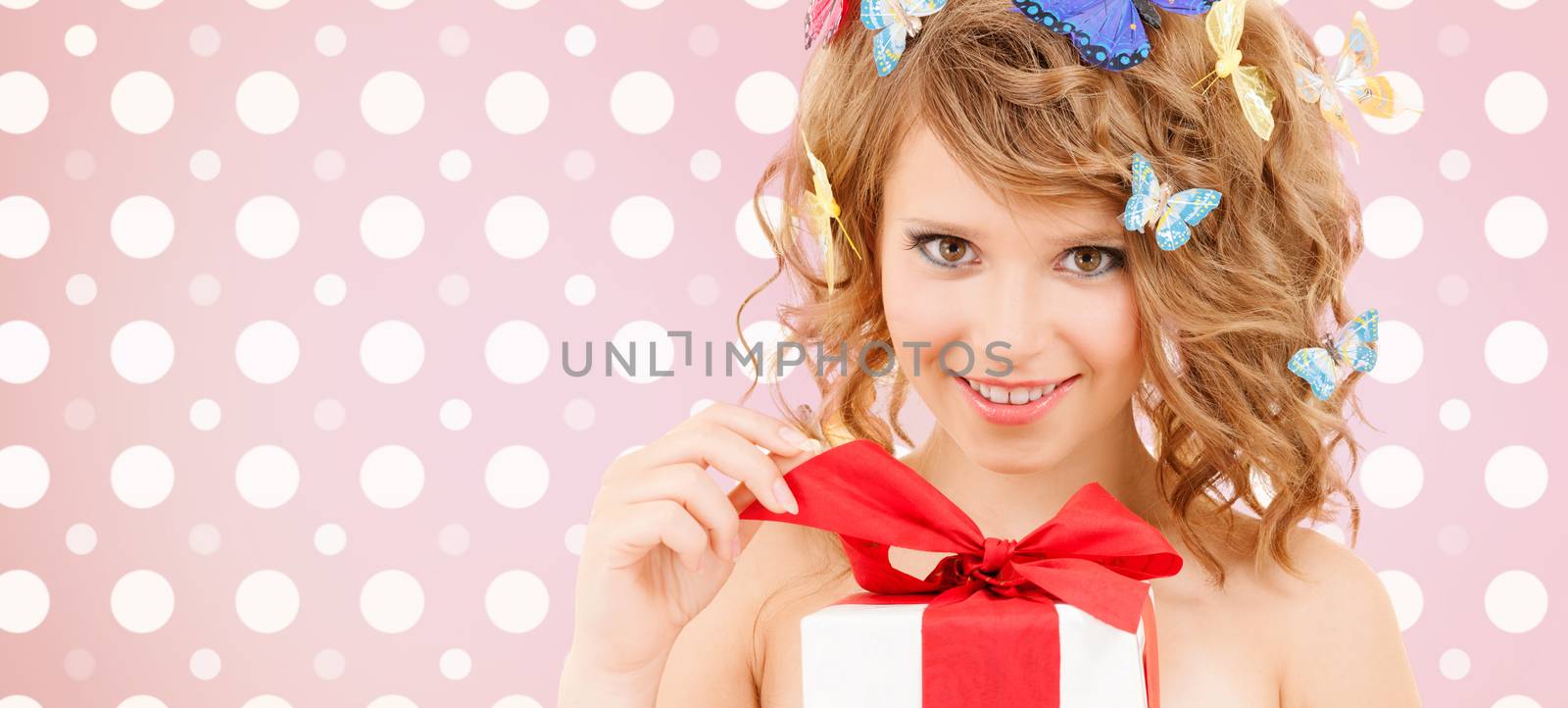 smiling young woman with gift box by dolgachov