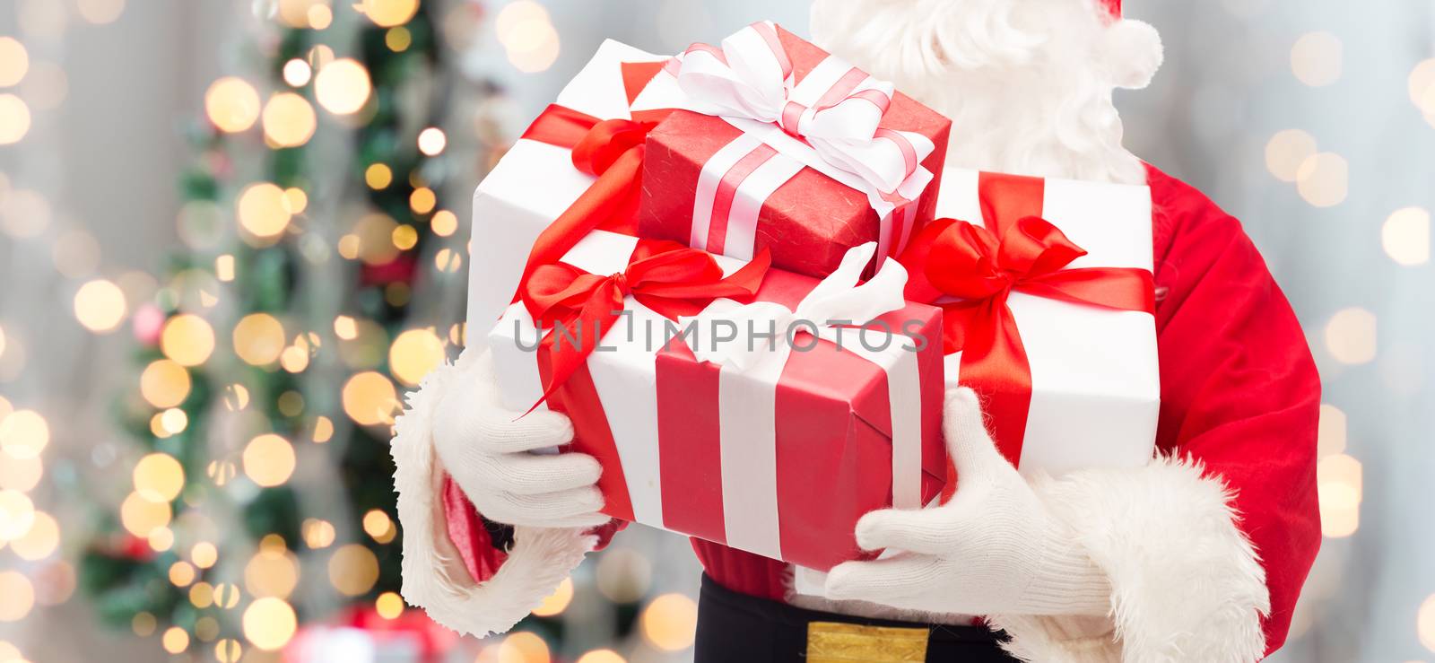 man in costume of santa claus with gift box by dolgachov