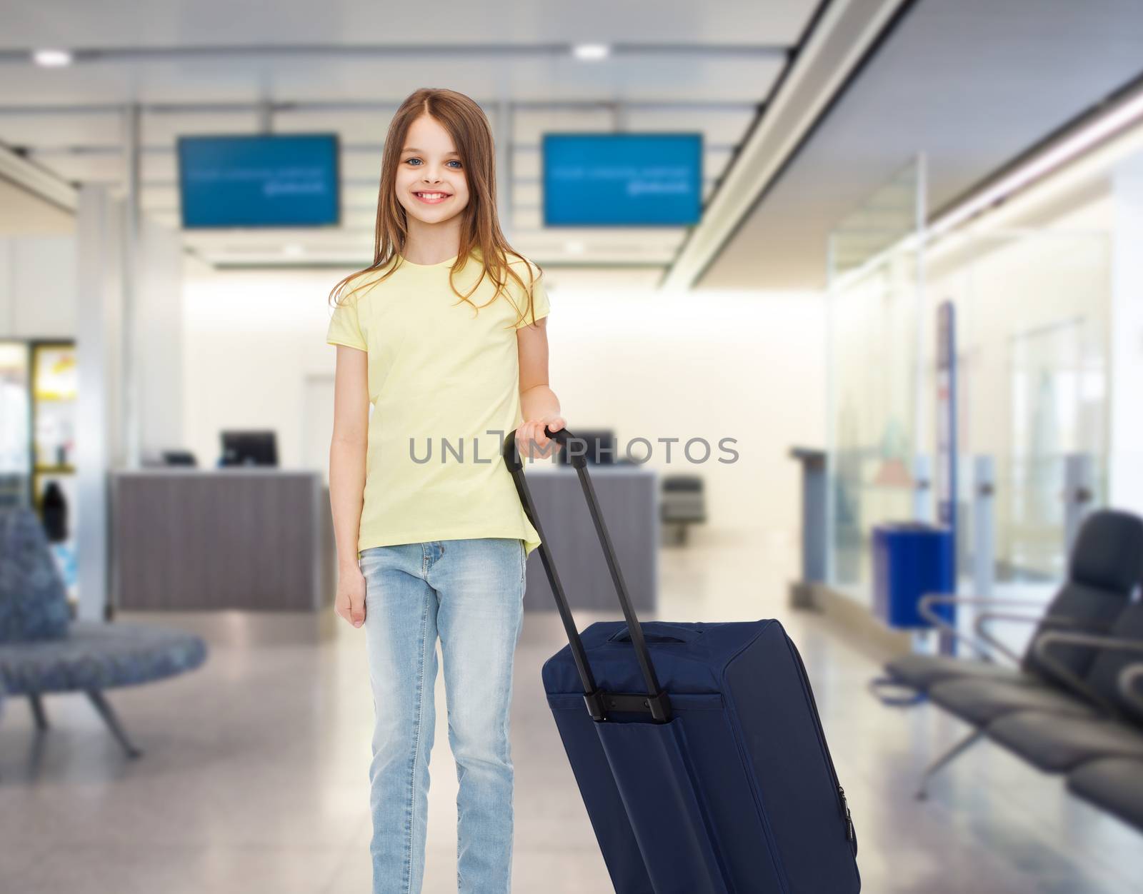 smiling girl with travel bag in airport by dolgachov