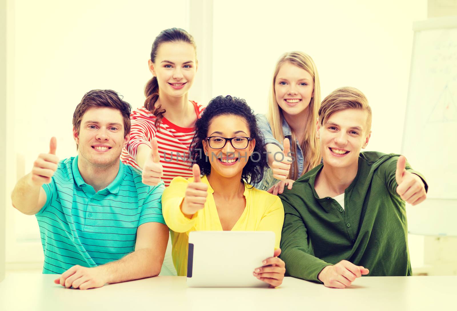 smiling students with tablet pc computer at school by dolgachov