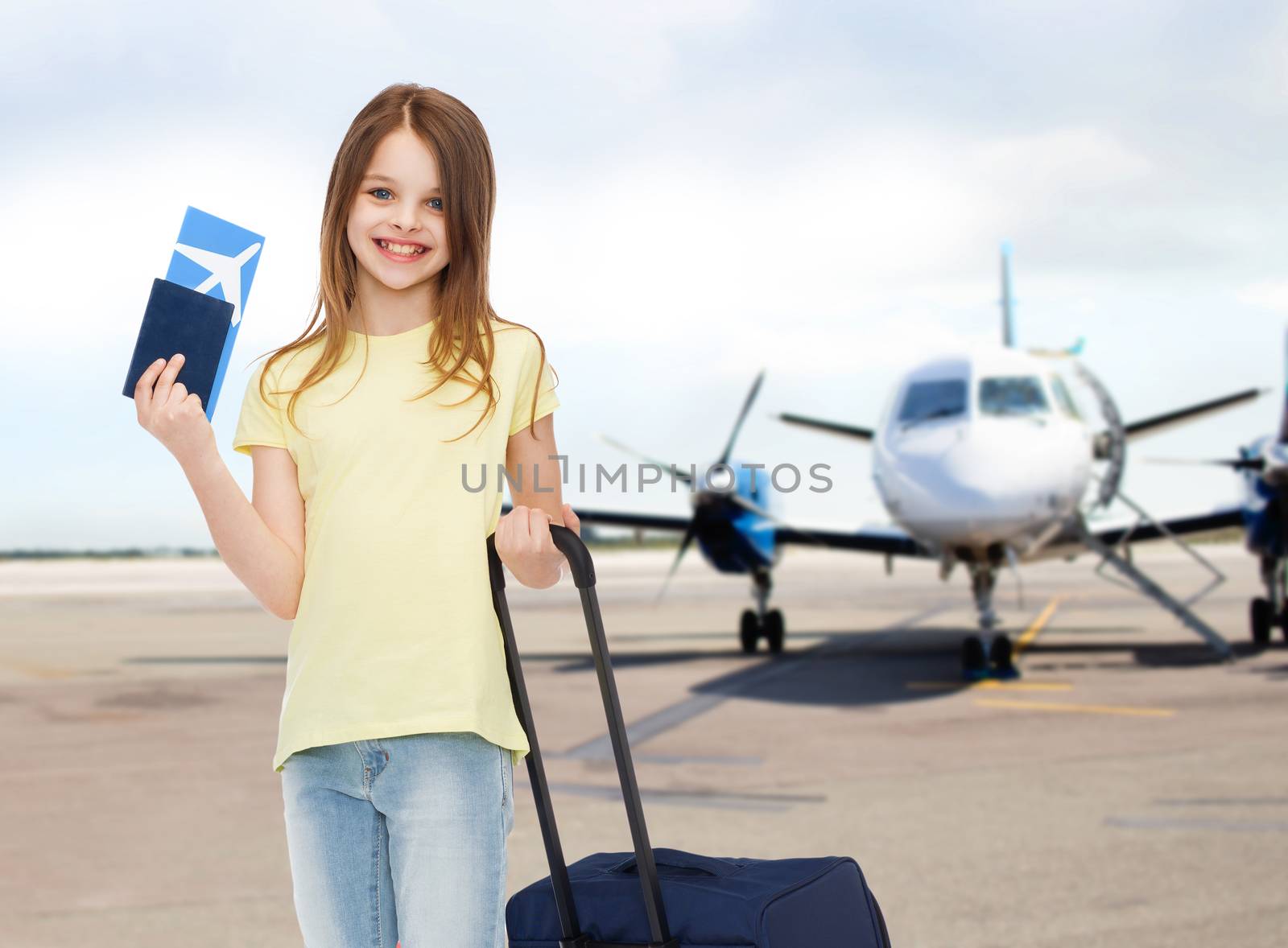 smiling girl with travel bag ticket and passport by dolgachov