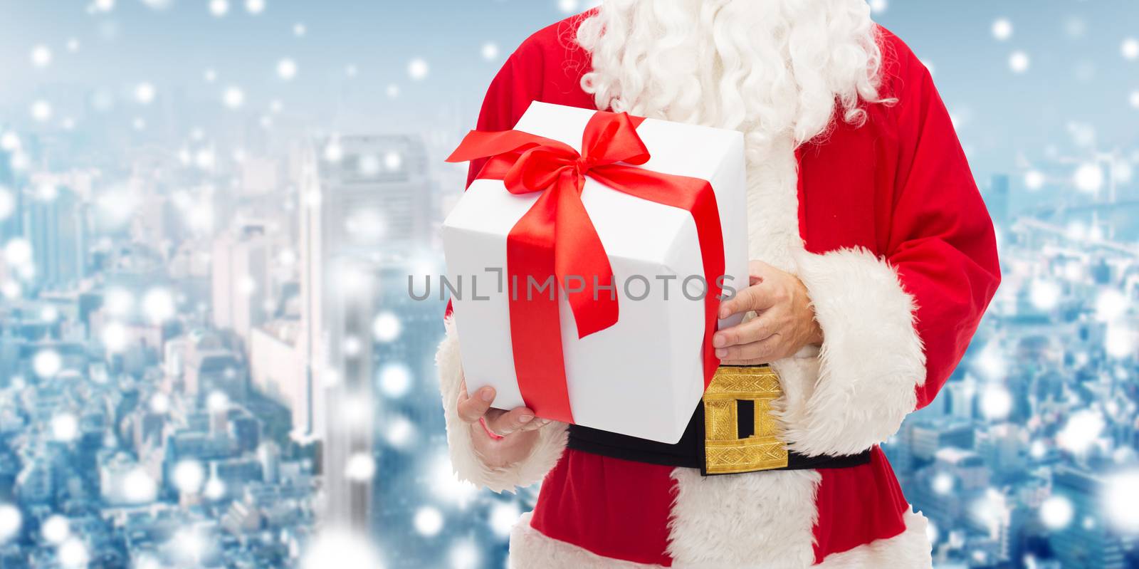 man in costume of santa claus with gift box by dolgachov