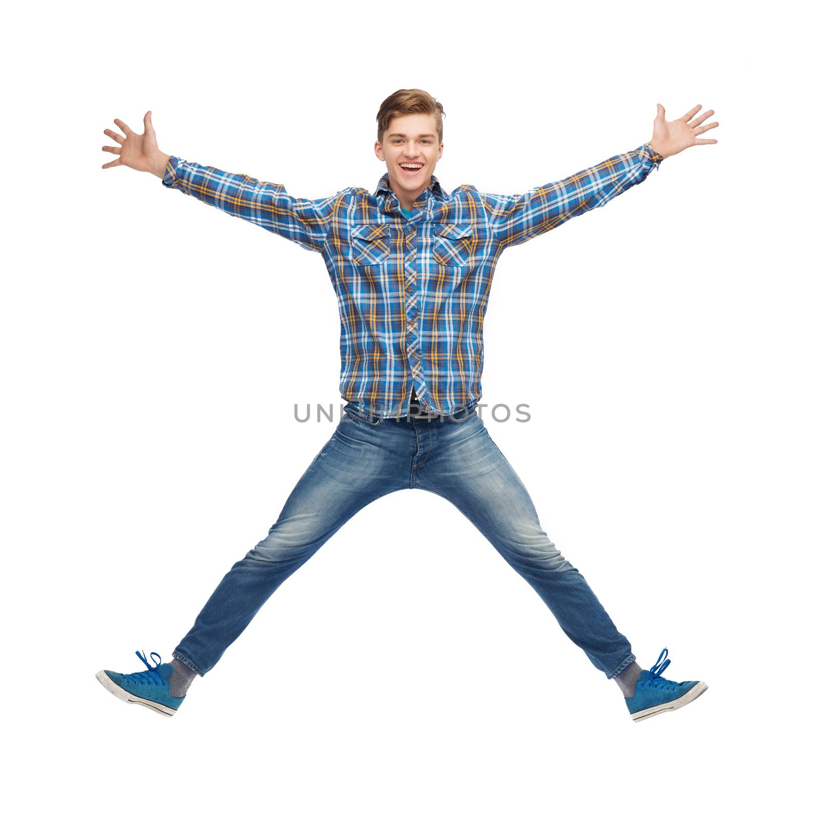 smiling young man jumping in air by dolgachov
