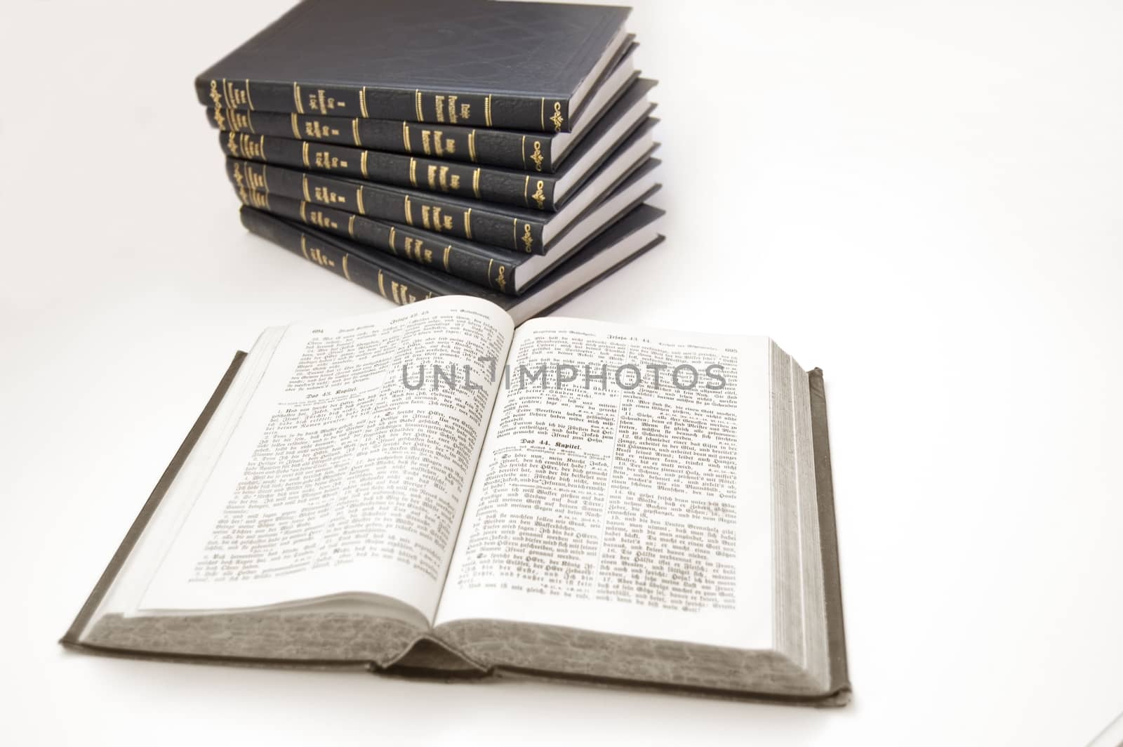 Bible conceptual image. Bible and other books on isolated background.