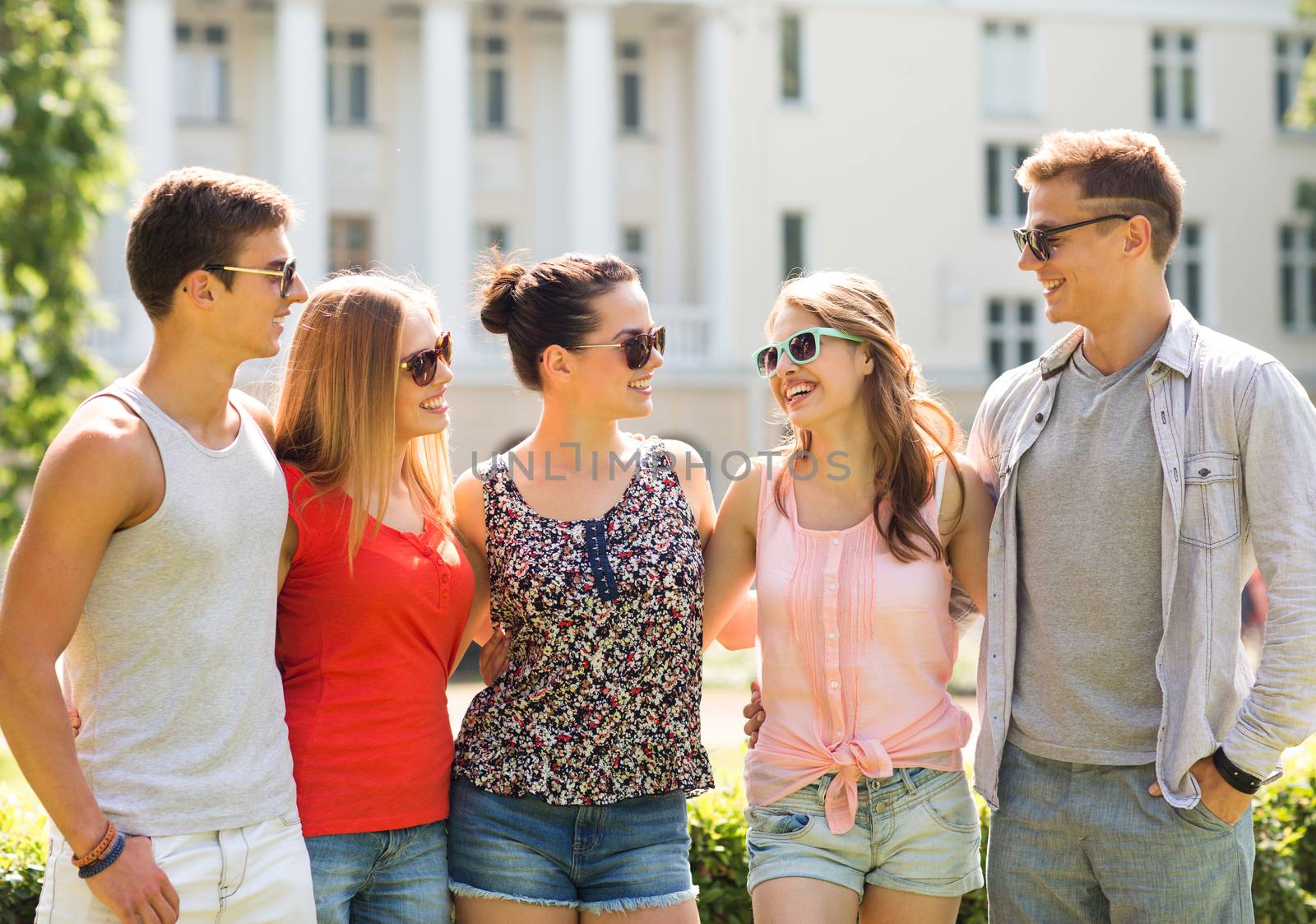 group of smiling friends outdoors by dolgachov