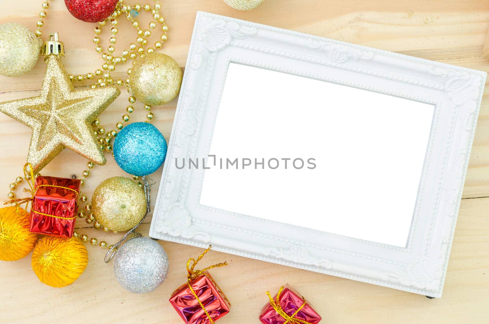 Vintage white blank photo frame with christmas decorations on wood background. Save clipping path.