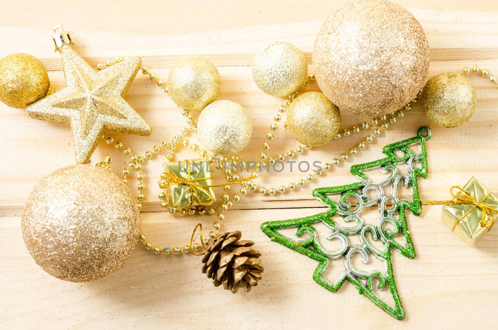 Golden Christmas decorations on wooden background.