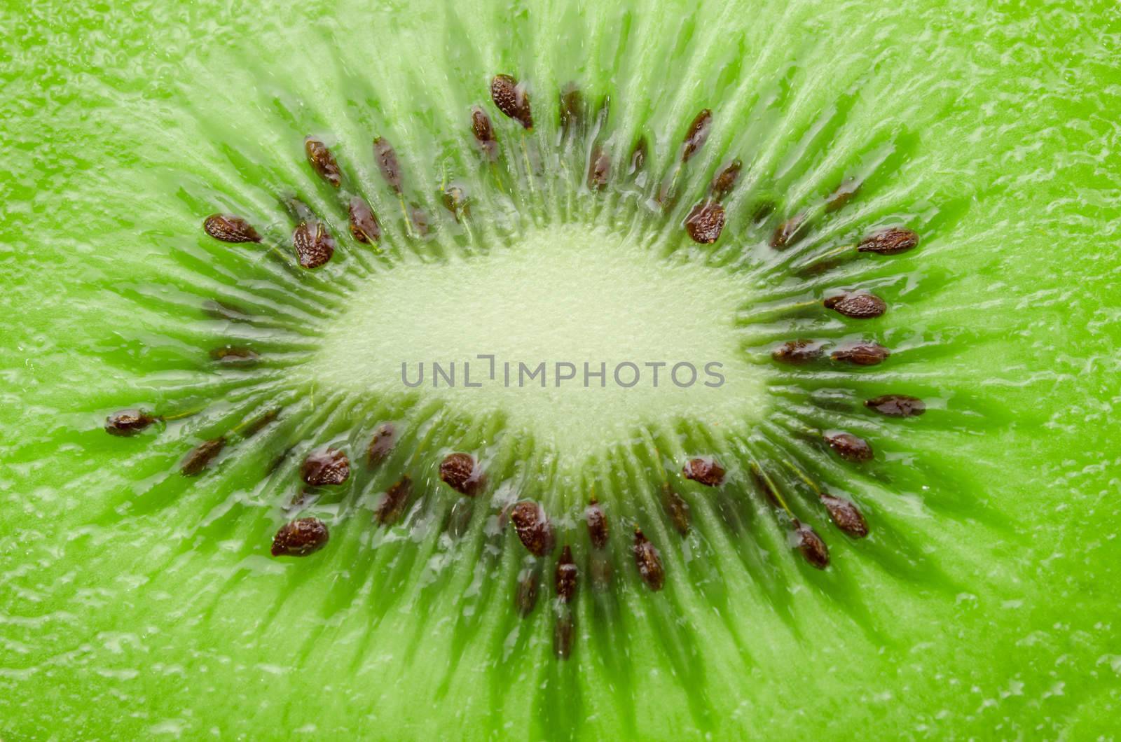 fresh juicy kiwi fruit slice closeup texture.