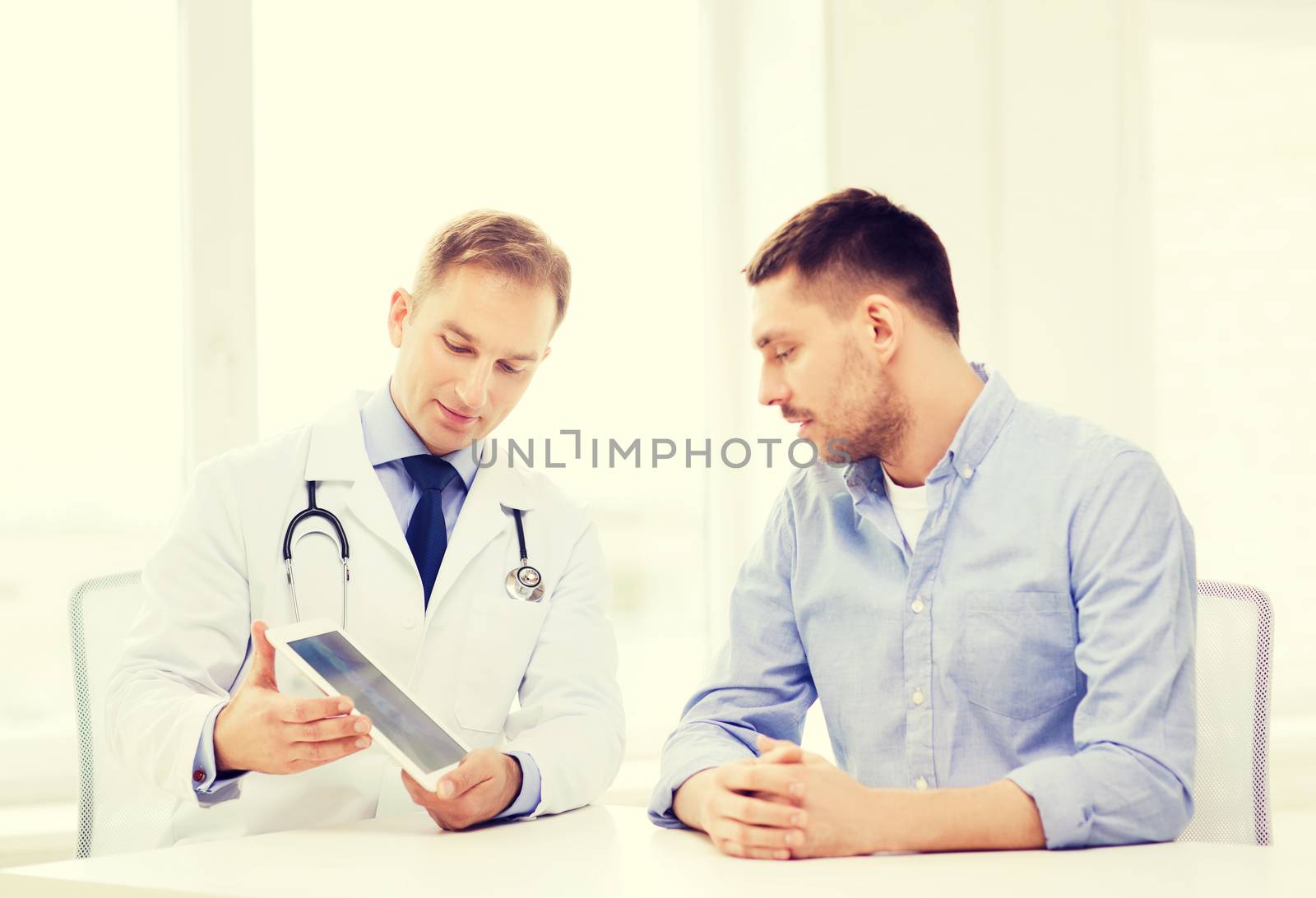 doctor with tablet pc and patient in hospital by dolgachov