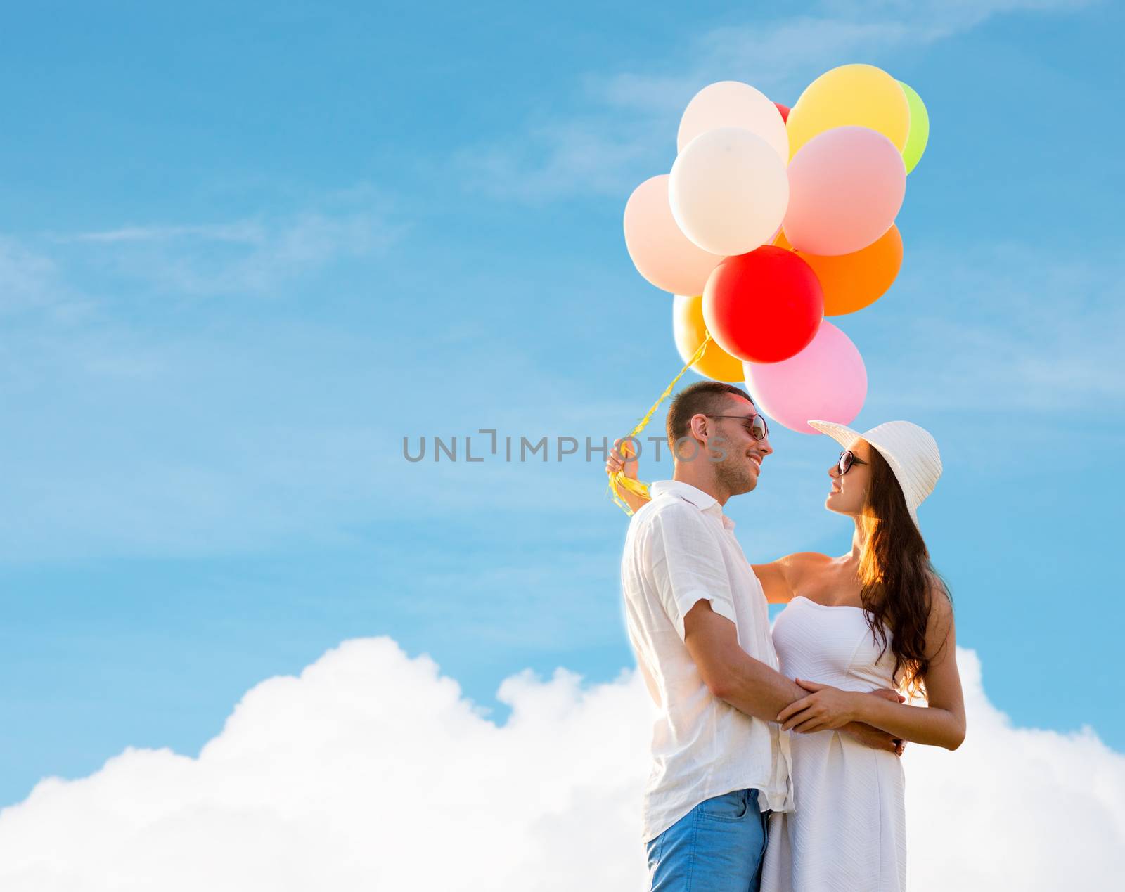 smiling couple with air balloons outdoors by dolgachov