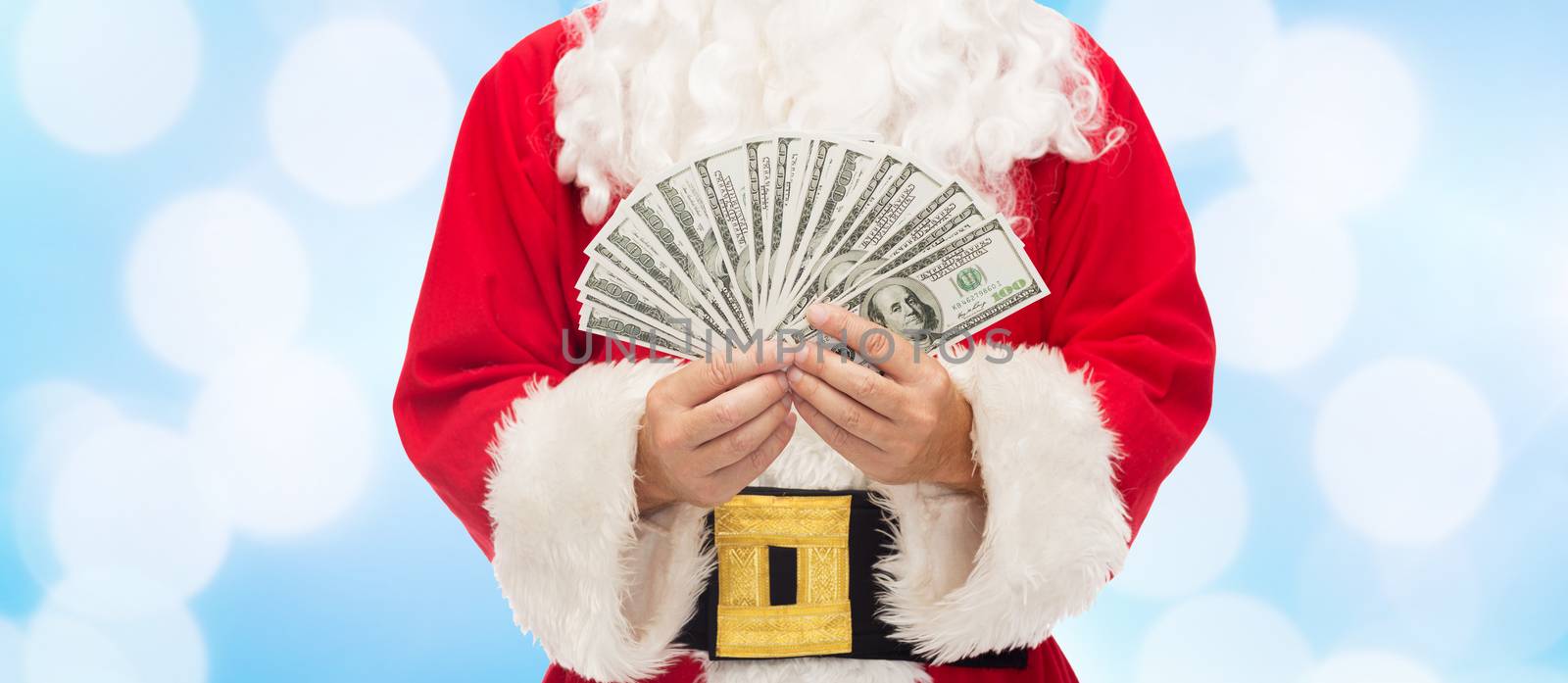 close up of santa claus with dollar money by dolgachov