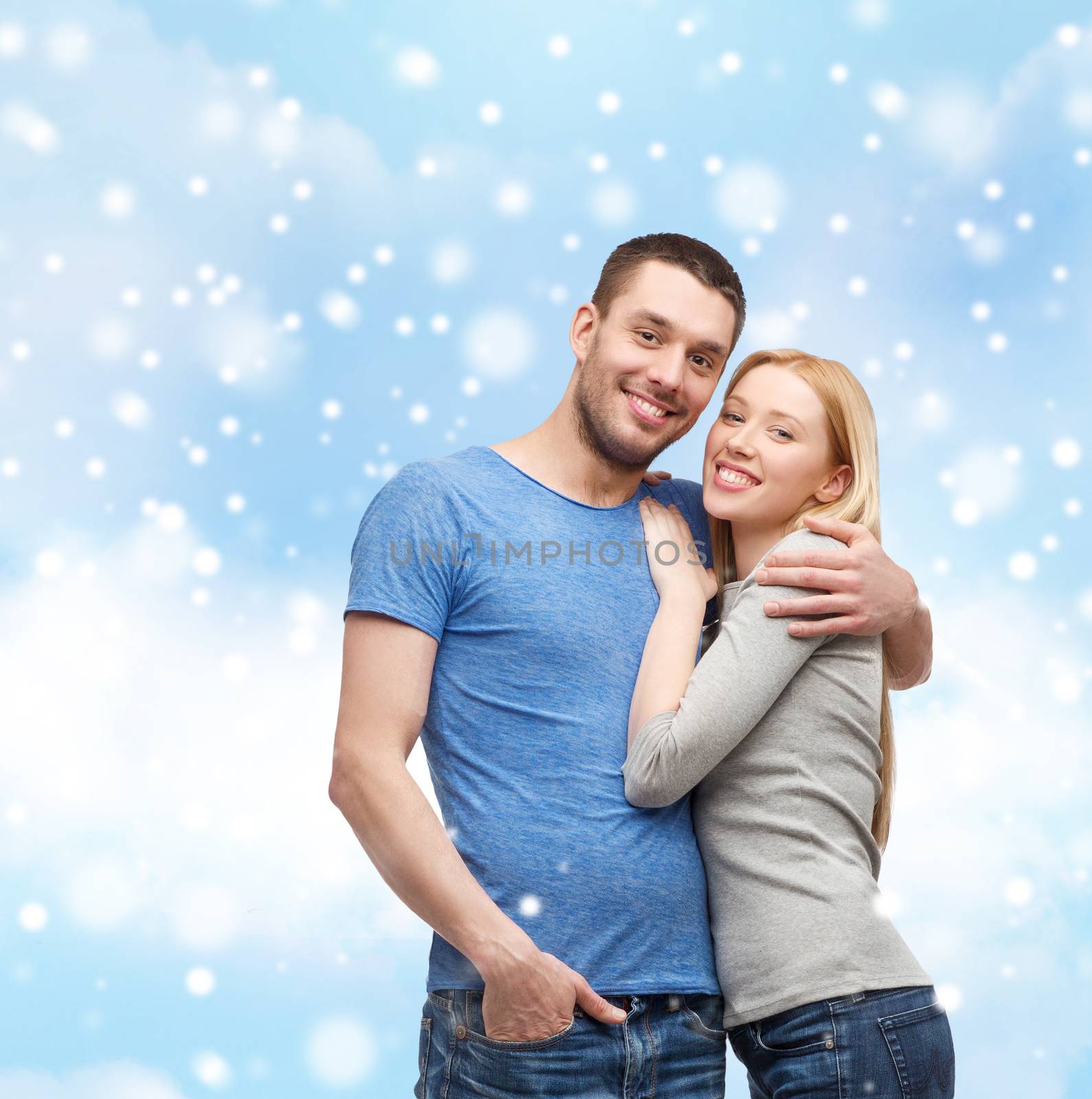 love, people and family concept - smiling couple hugging over blue sky, snow and cloud background