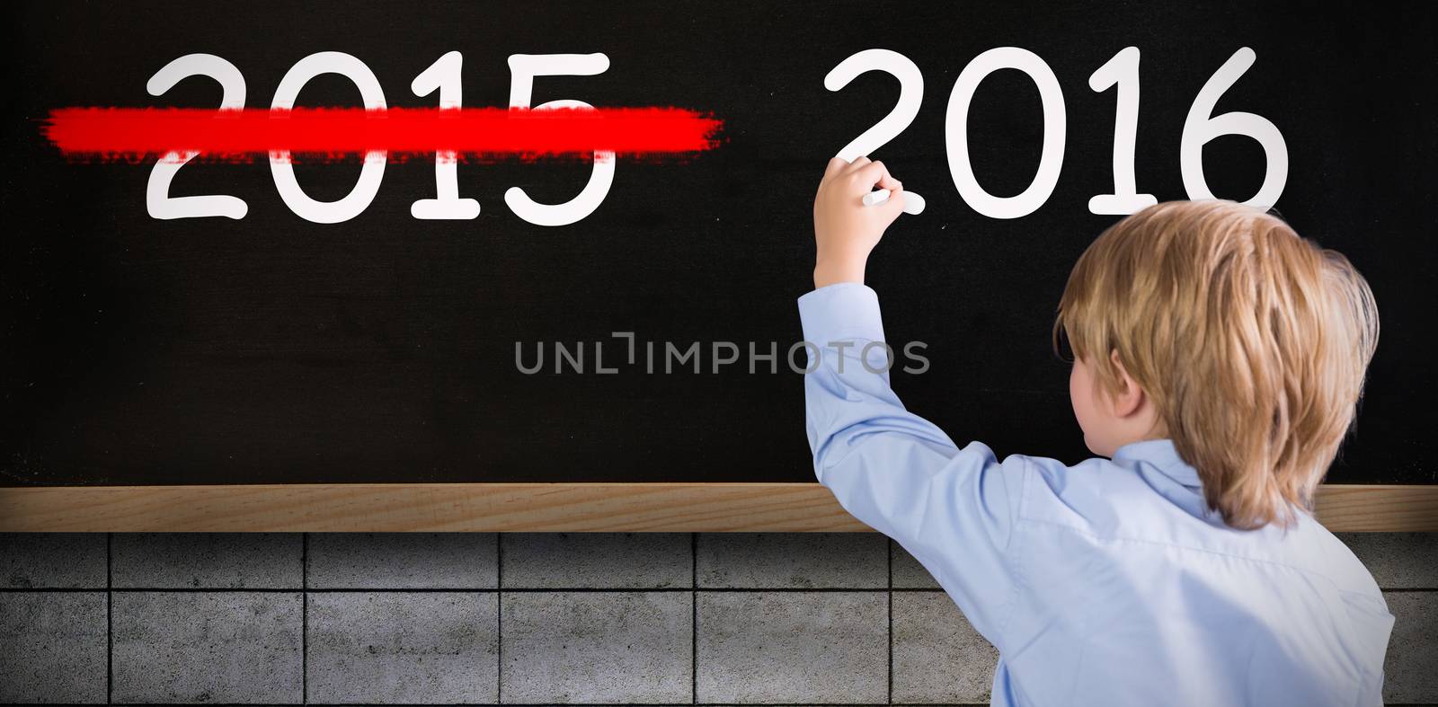 Cute pupil writing against blackboard on wall