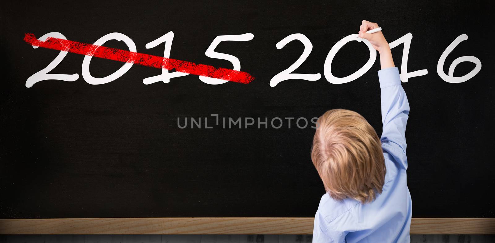 Cute pupil writing against blackboard on wall