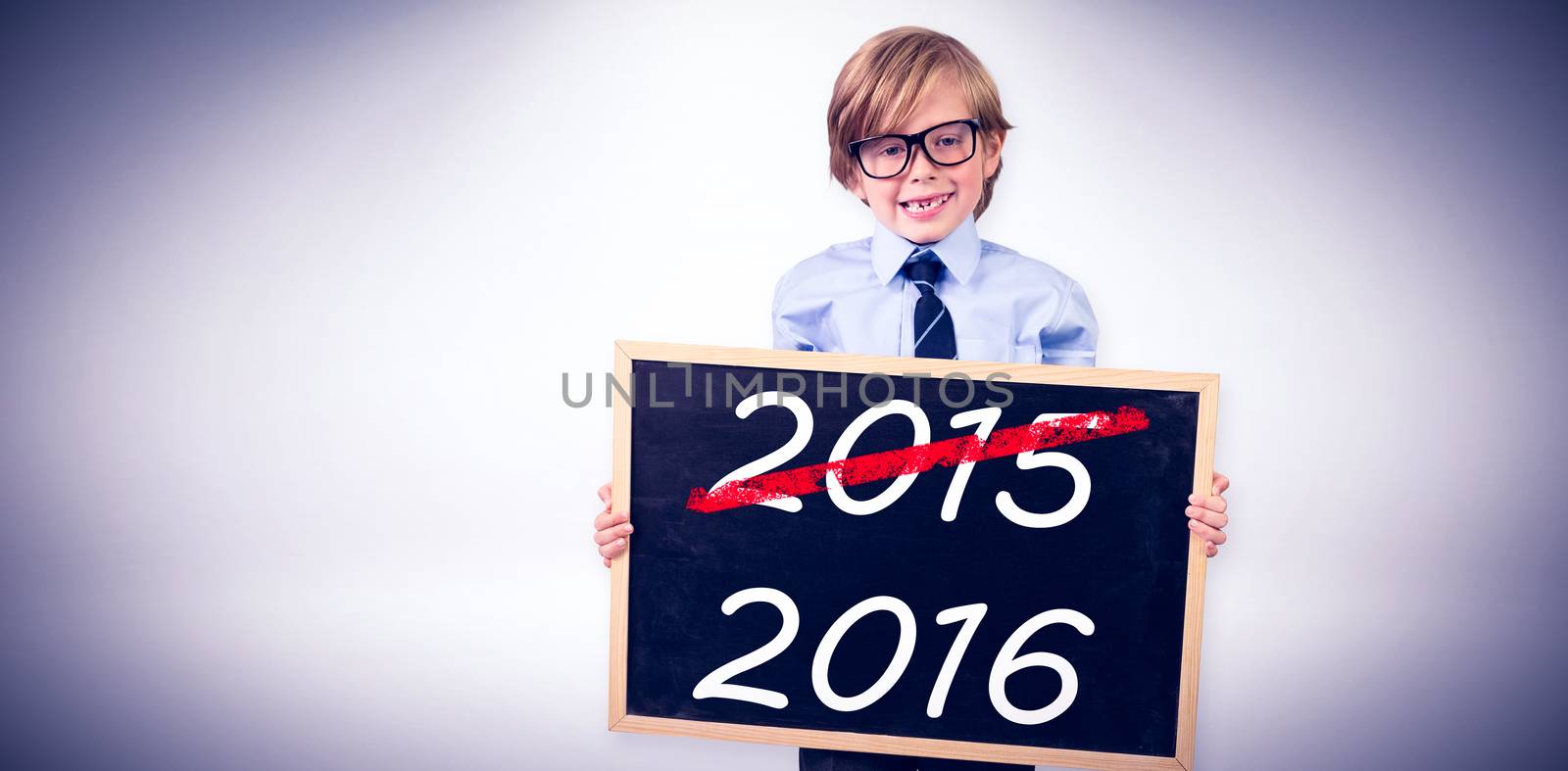 Cute pupil holding chalkboard against grey background