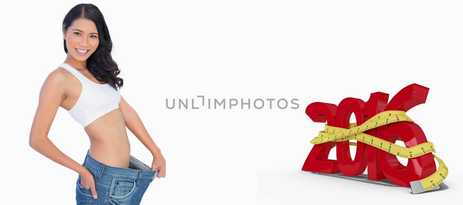 Cheerful woman holding her too big pants against white background with vignette