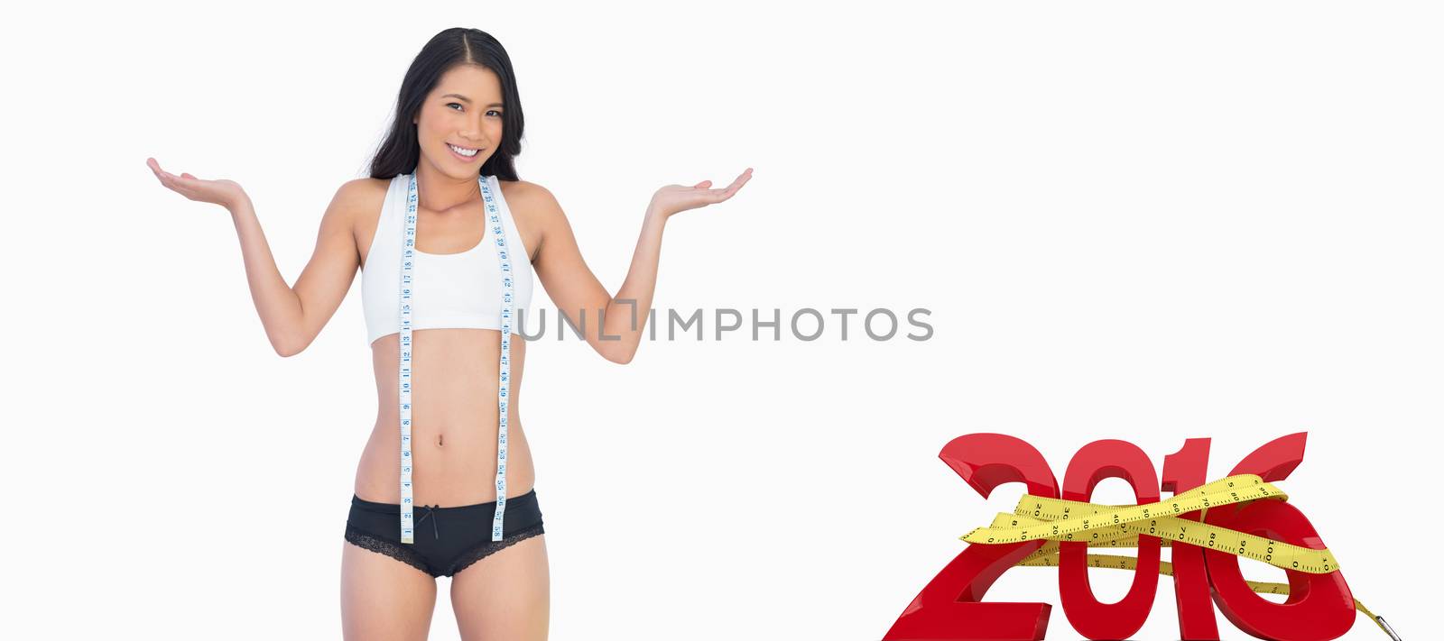 Smiling woman wearing jeans falling down because shes lost weight against white background with vignette