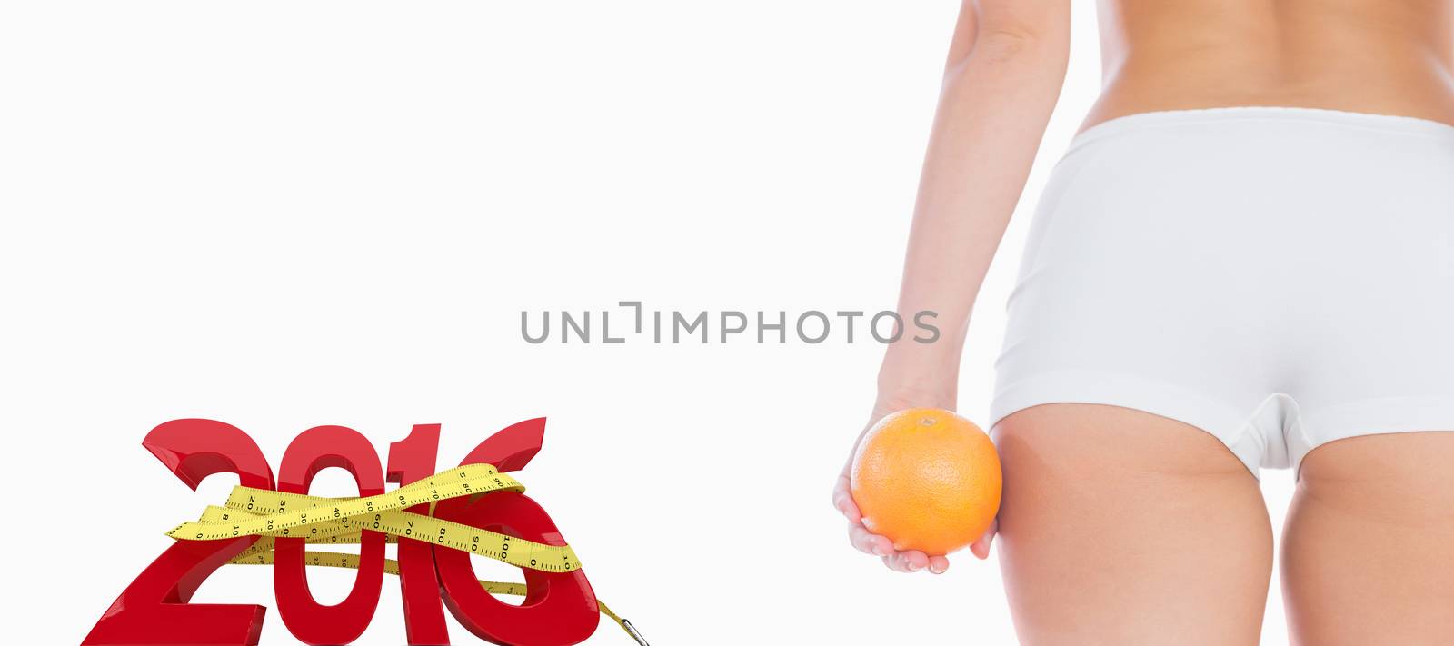 Midsection of fit woman with orange against white background with vignette