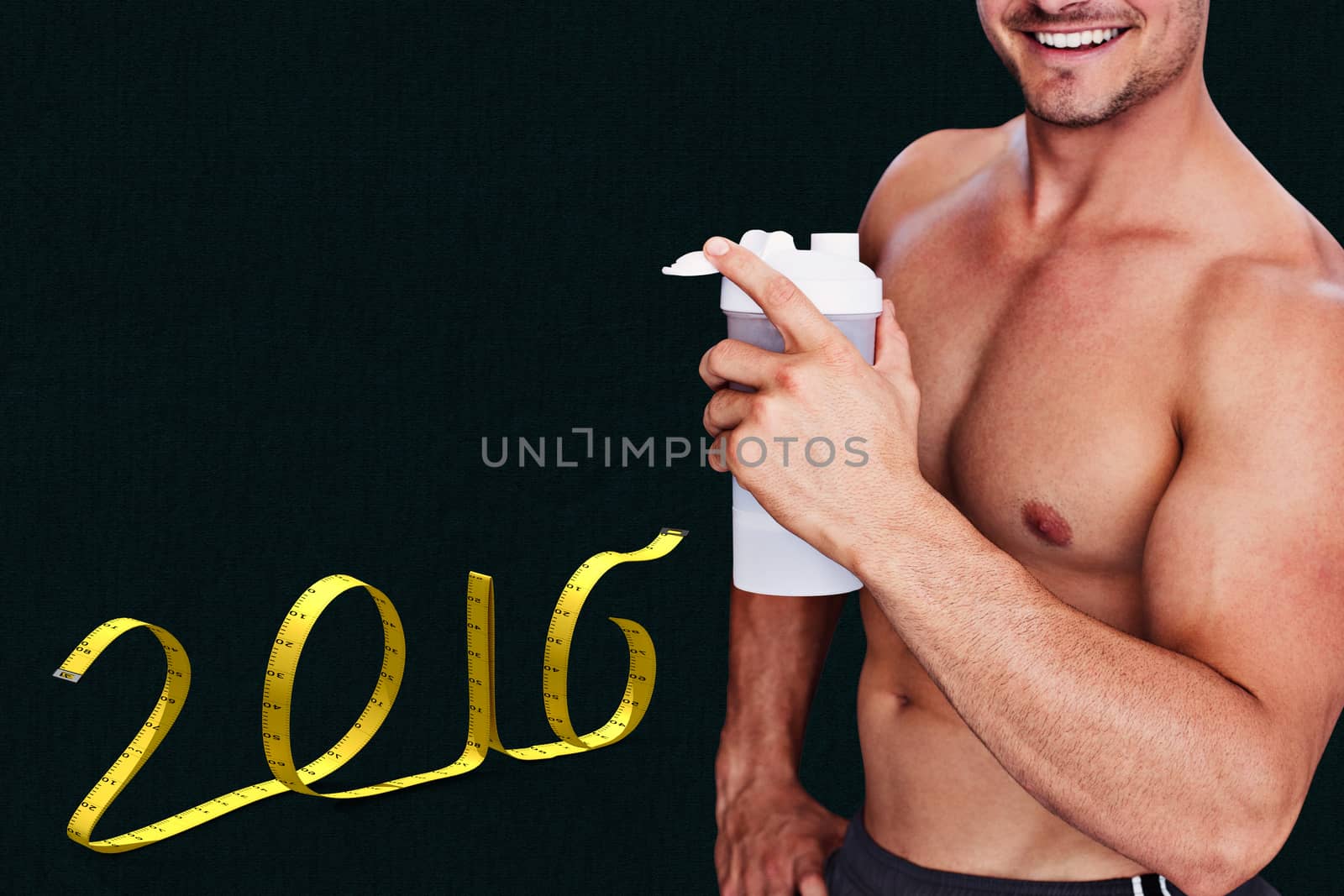 Bodybuilder holding flask against grey background