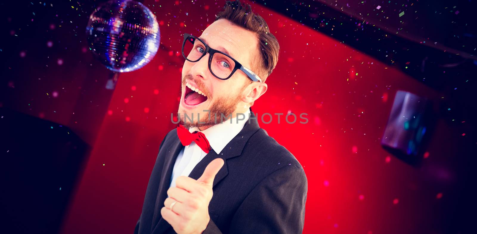 Geeky hipster pointing at camera against pretty brunette dancing and smiling