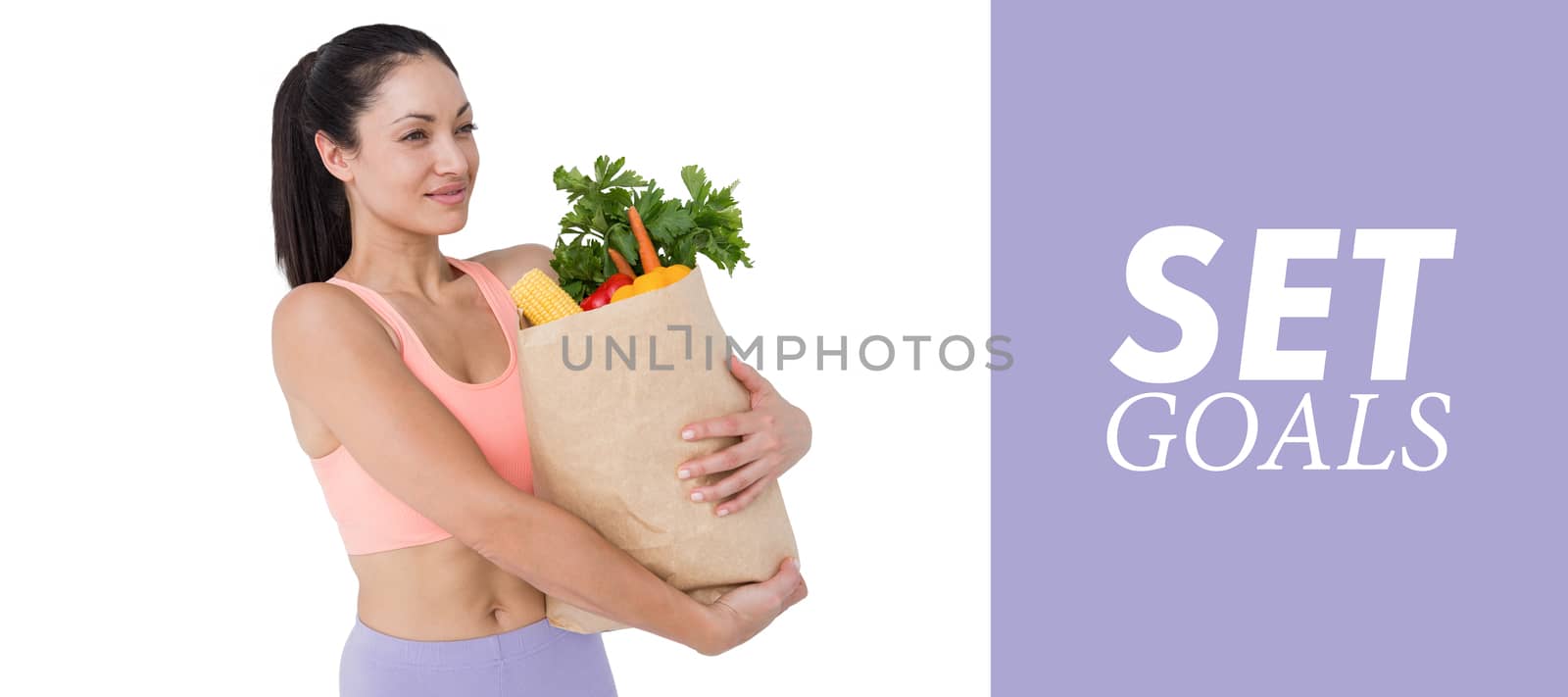 Composite image of slim woman holding bag with healthy food by Wavebreakmedia