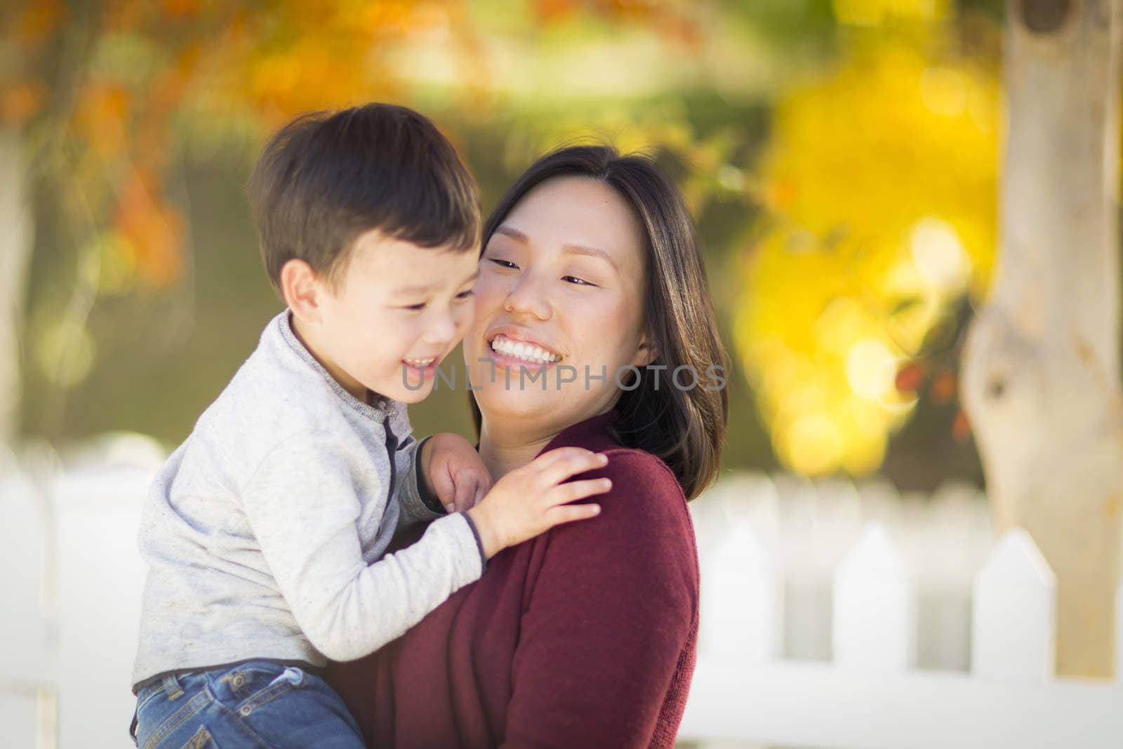 Happy Chinese Mom Having Fun and Holding Her Mixed Race Little Boy.