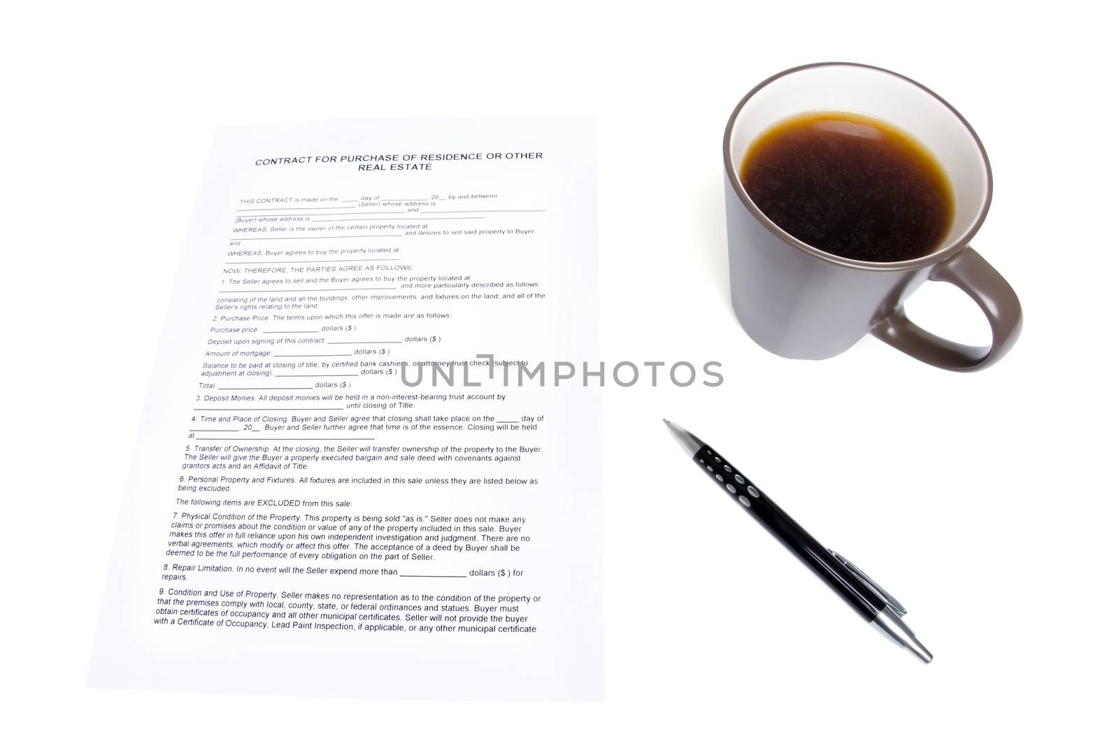 Still life consisting of real estate contract, pen and a cup of coffee.