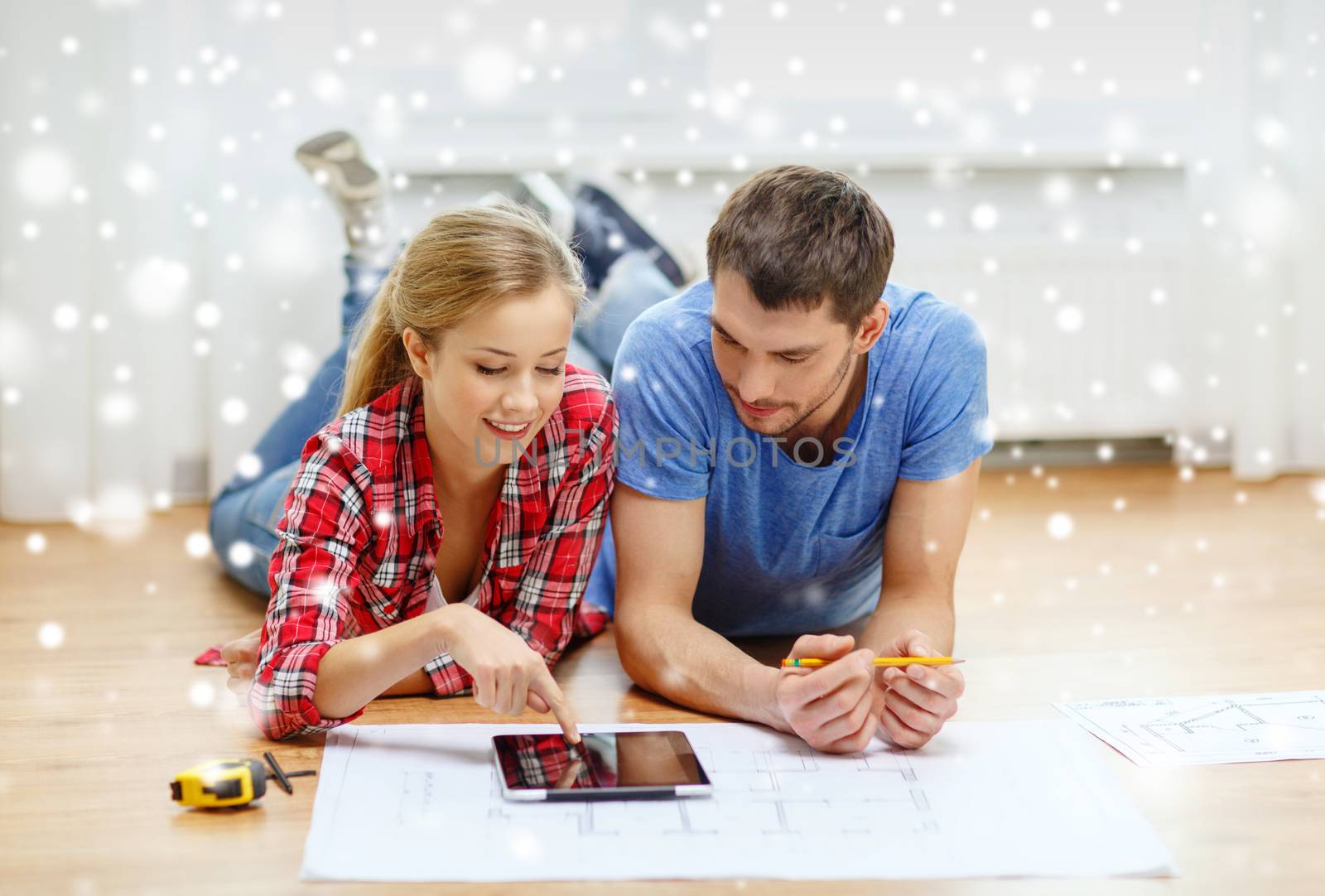 smiling couple with tablet pc at home by dolgachov