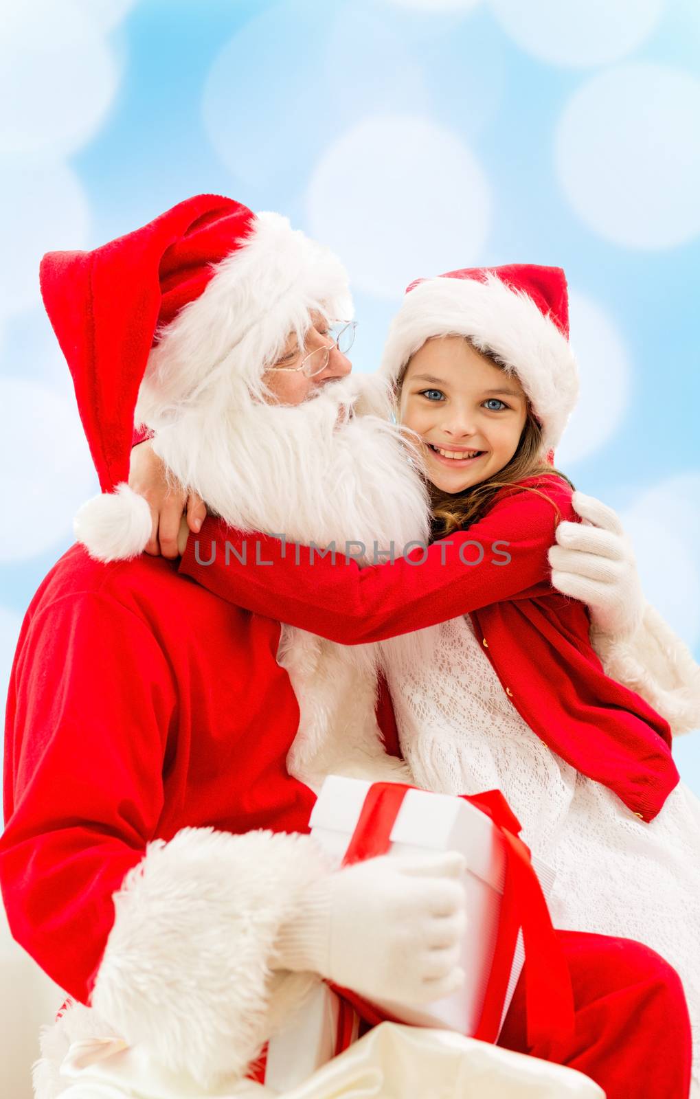 smiling little girl with santa claus by dolgachov