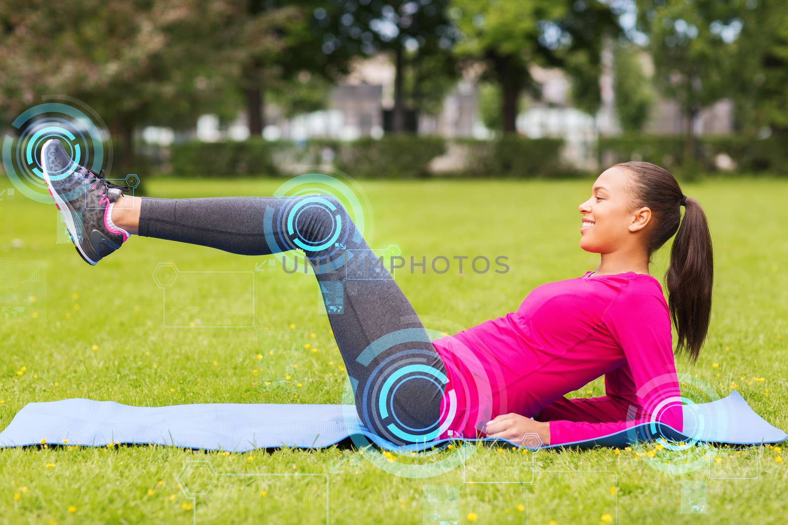 smiling woman doing exercises on mat outdoors by dolgachov