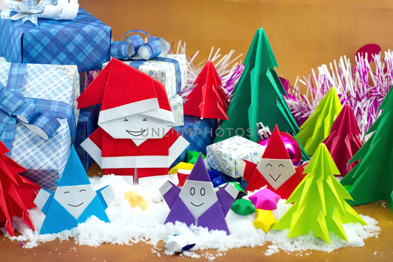 Santa claus and gift box with small star paper on the snow field.
