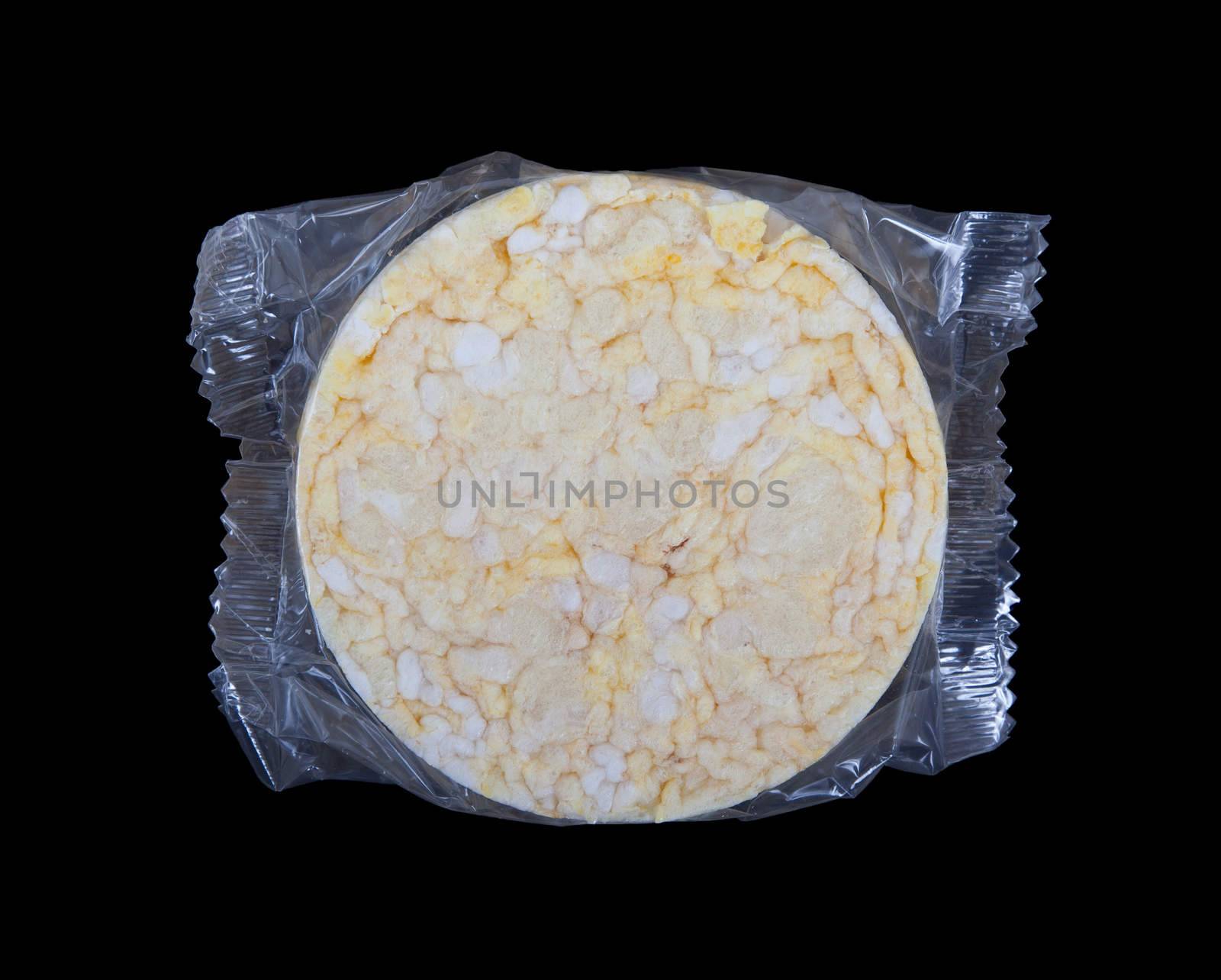 Rice cracker in plastic, isolated on black