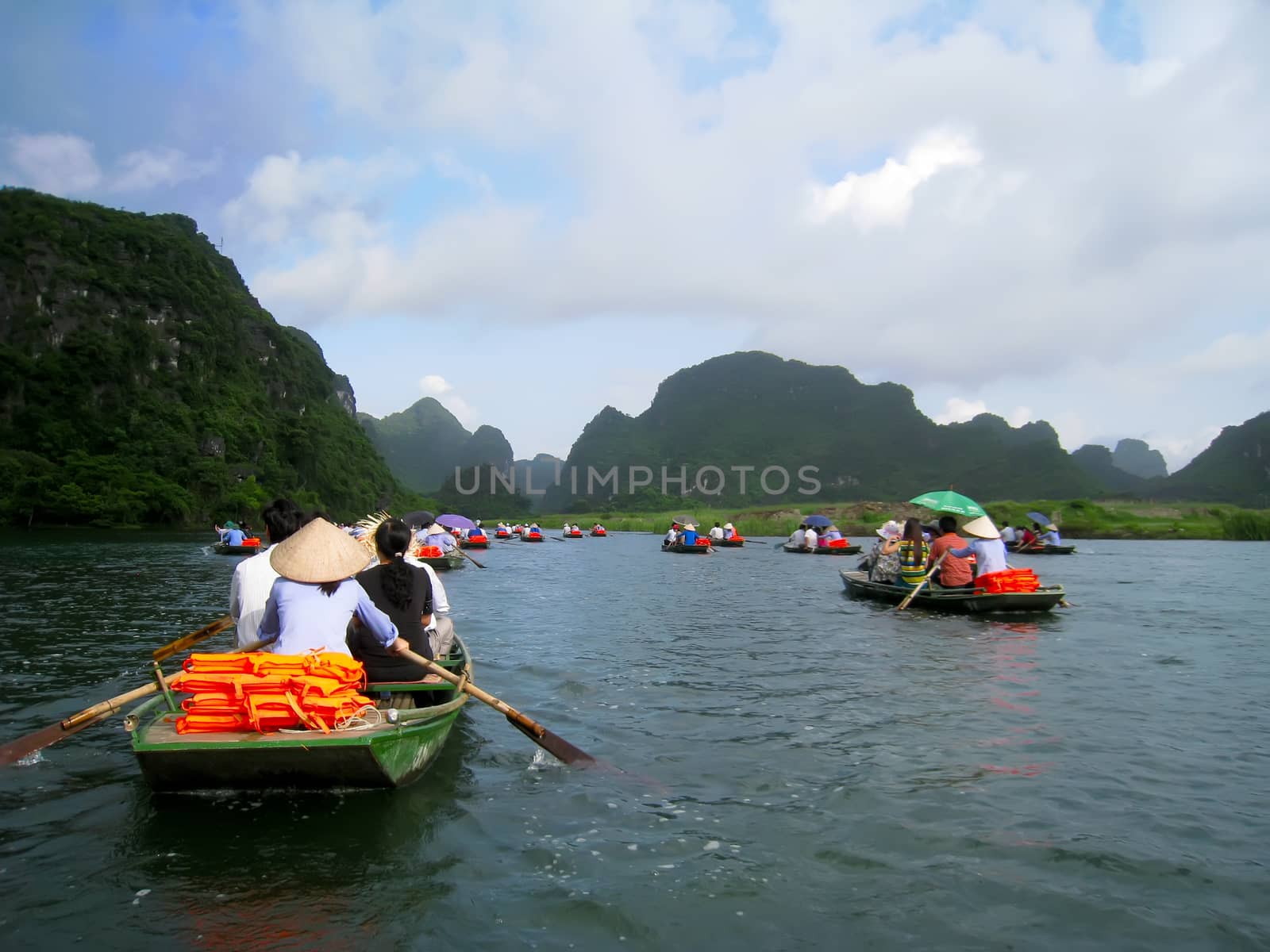 NINH BINH, VIETNAM, JULY, 20: Unidentified tourists in Trang An  on JULY, 20, 2013. Trang An is the scenic area, ranked special of Vietnam.