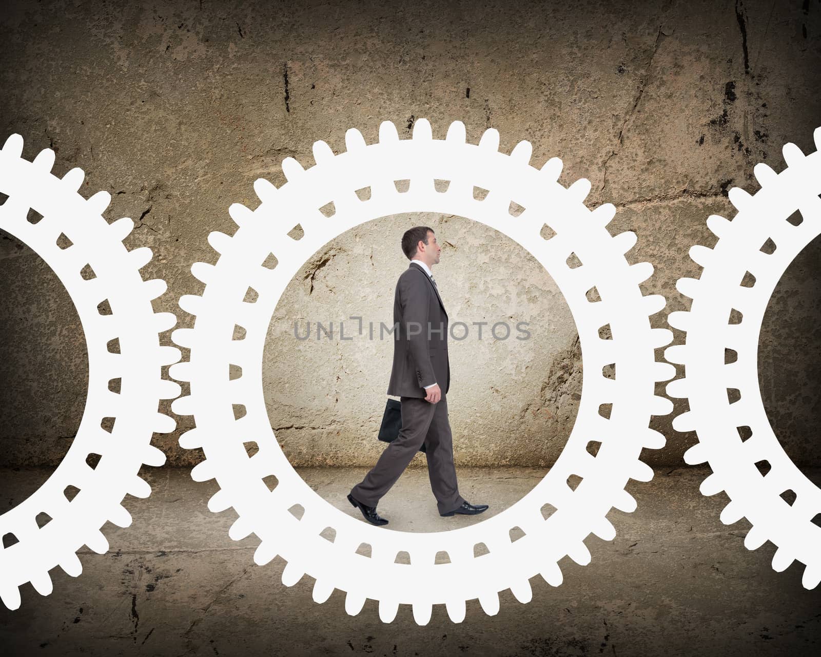 Man walking in cog wheel by cherezoff