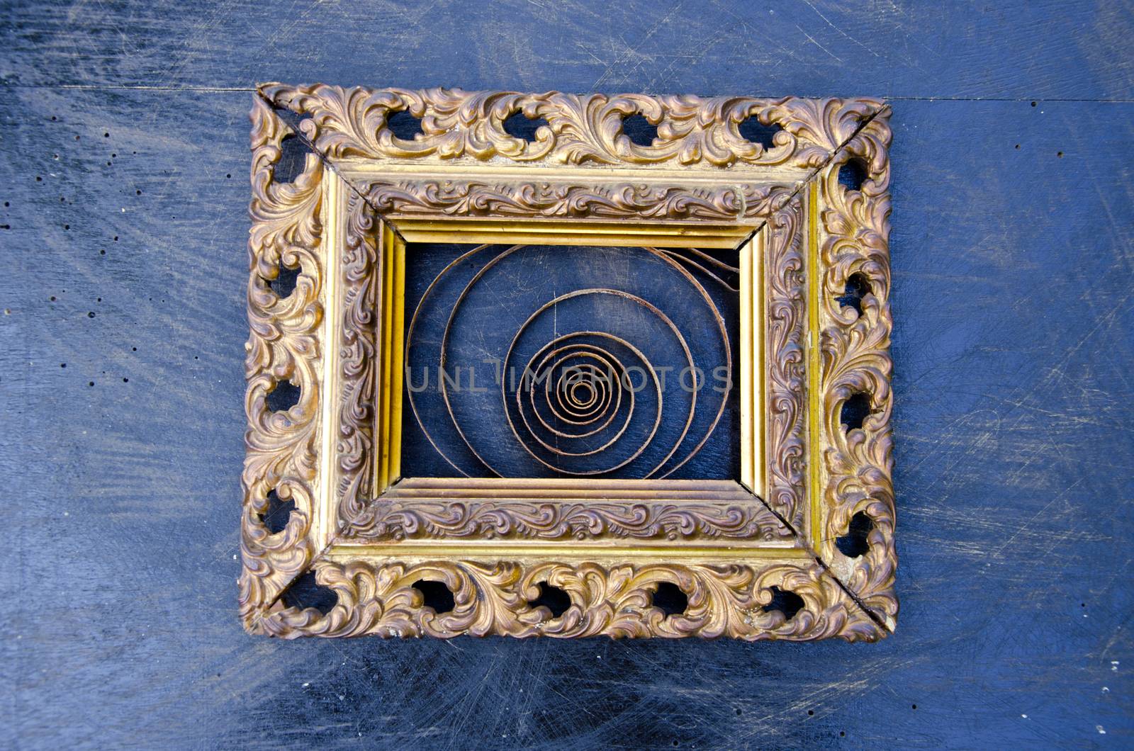 Golden ornate frame with a spiral on black background by alis_photo
