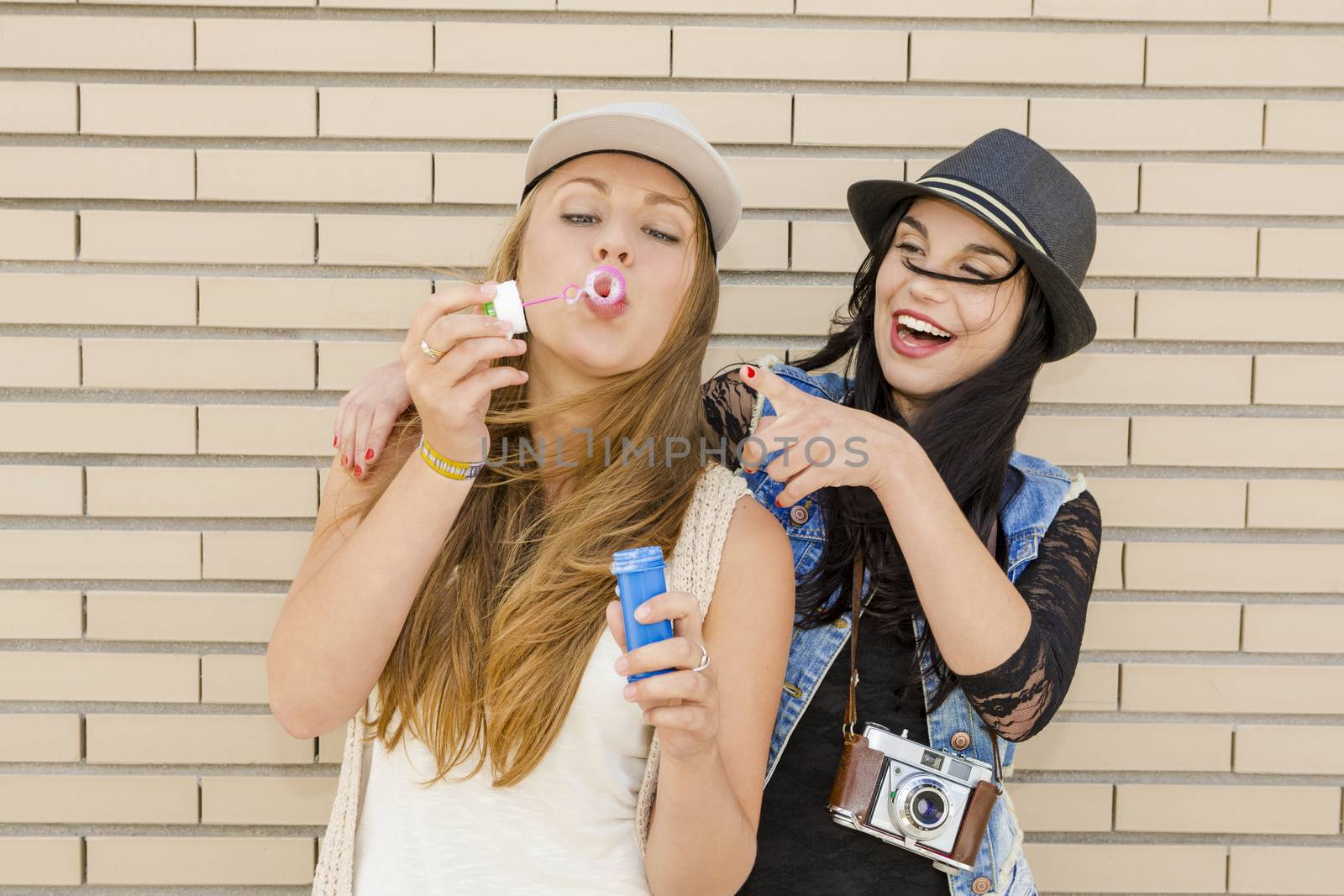 Teenage firends playing with soap bubbles