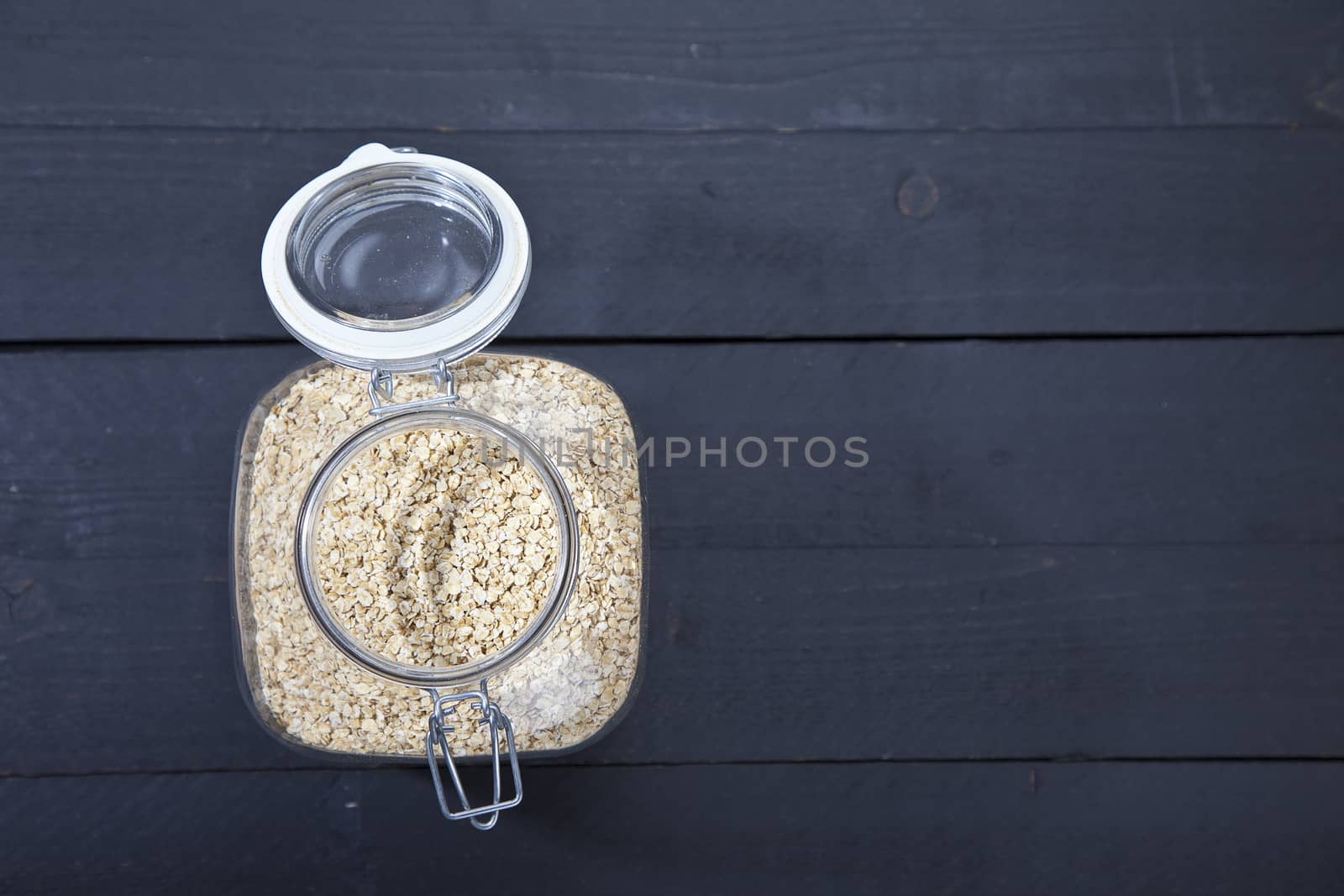 Oatmeal on dark wooden background