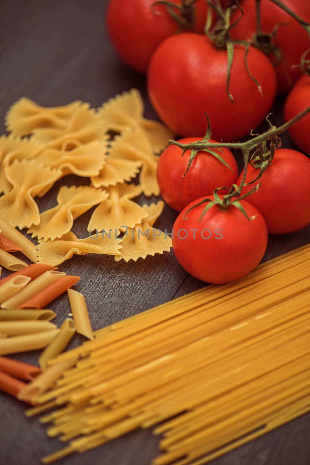 food background on rustic wood with pasta and tomatoes