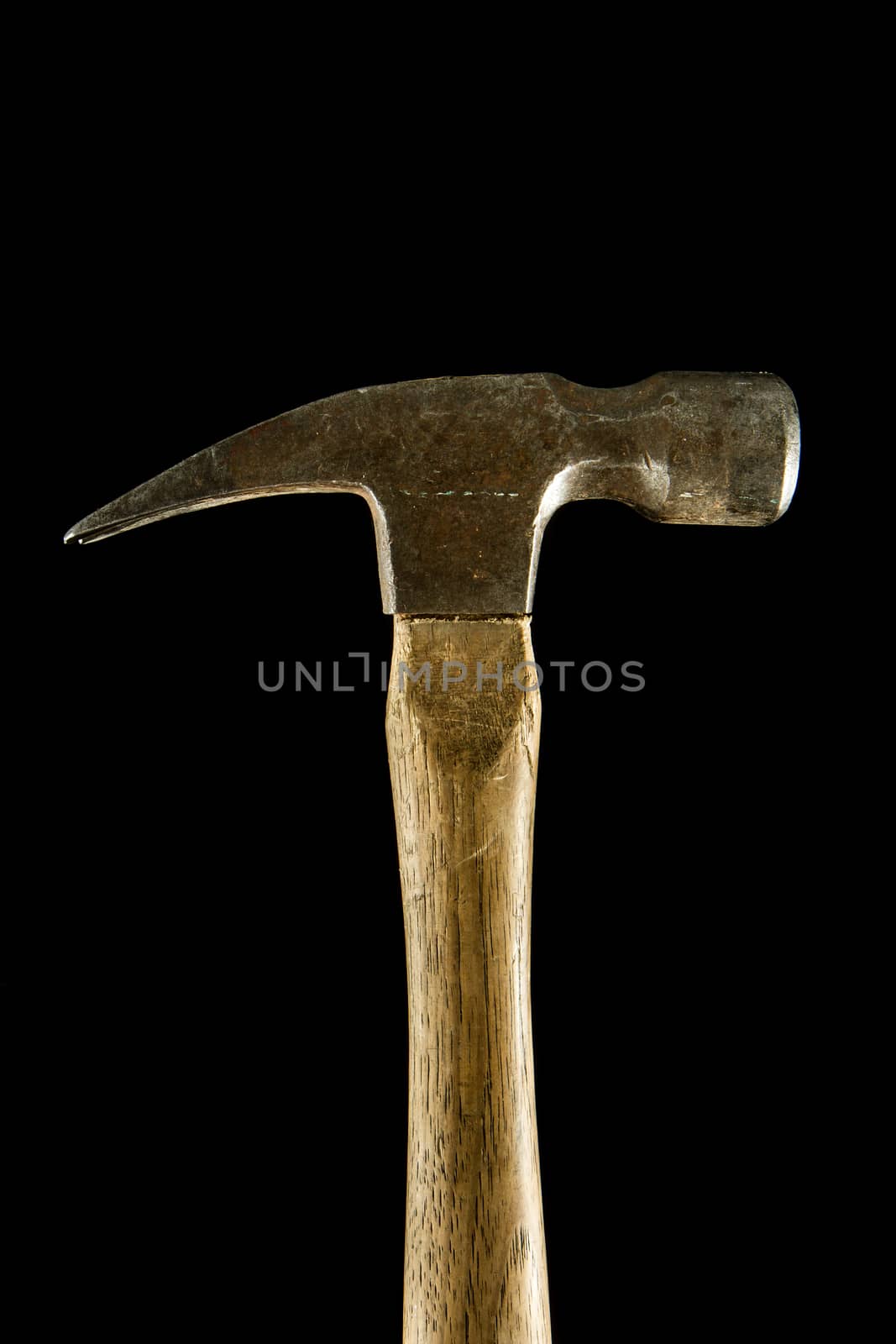 Isolated profile view of a hammer against a black background