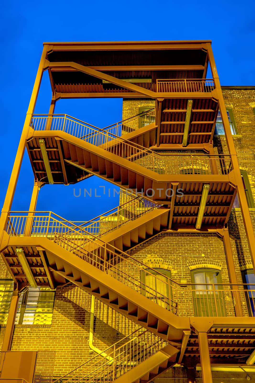 emergency exterior stair case on side of building  by digidreamgrafix