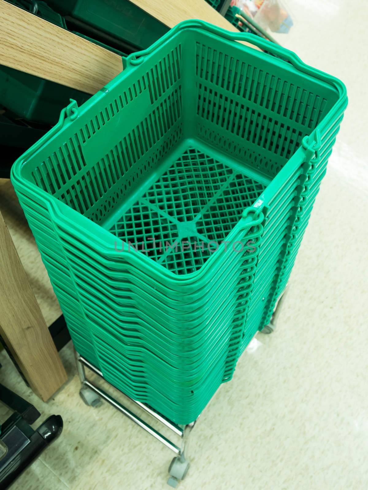 This is green shopping baskets in supermarket.